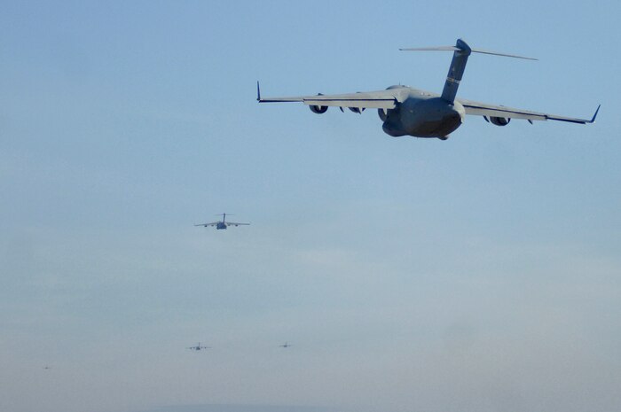 Charleston AFB C-17's fly as part of a 13 aircraft formation training exercise here Dec. 18.  The formation flight demonstrated the U.S. Air Force's strategic capability. The training mission included airdrops over North Auxiliary Airfield in Orangeburg, S.C., and aerial refueling training. (U.S. Air Force photo/Staff Sgt. Marie Cassetty)