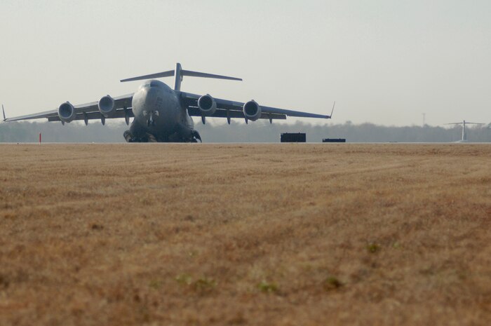 A Charleston AFB C-17 takes off as part of a 13 aircraft formation training mission here Dec. 18. The formation flight demonstrated the U.S. Air Force's strategic capability. The training mission included airdrops over North Auxiliary Airfield in Orangeburg, S.C., and aerial refueling training. (U.S. Air Force photo/Staff Sgt. Marie Cassetty)