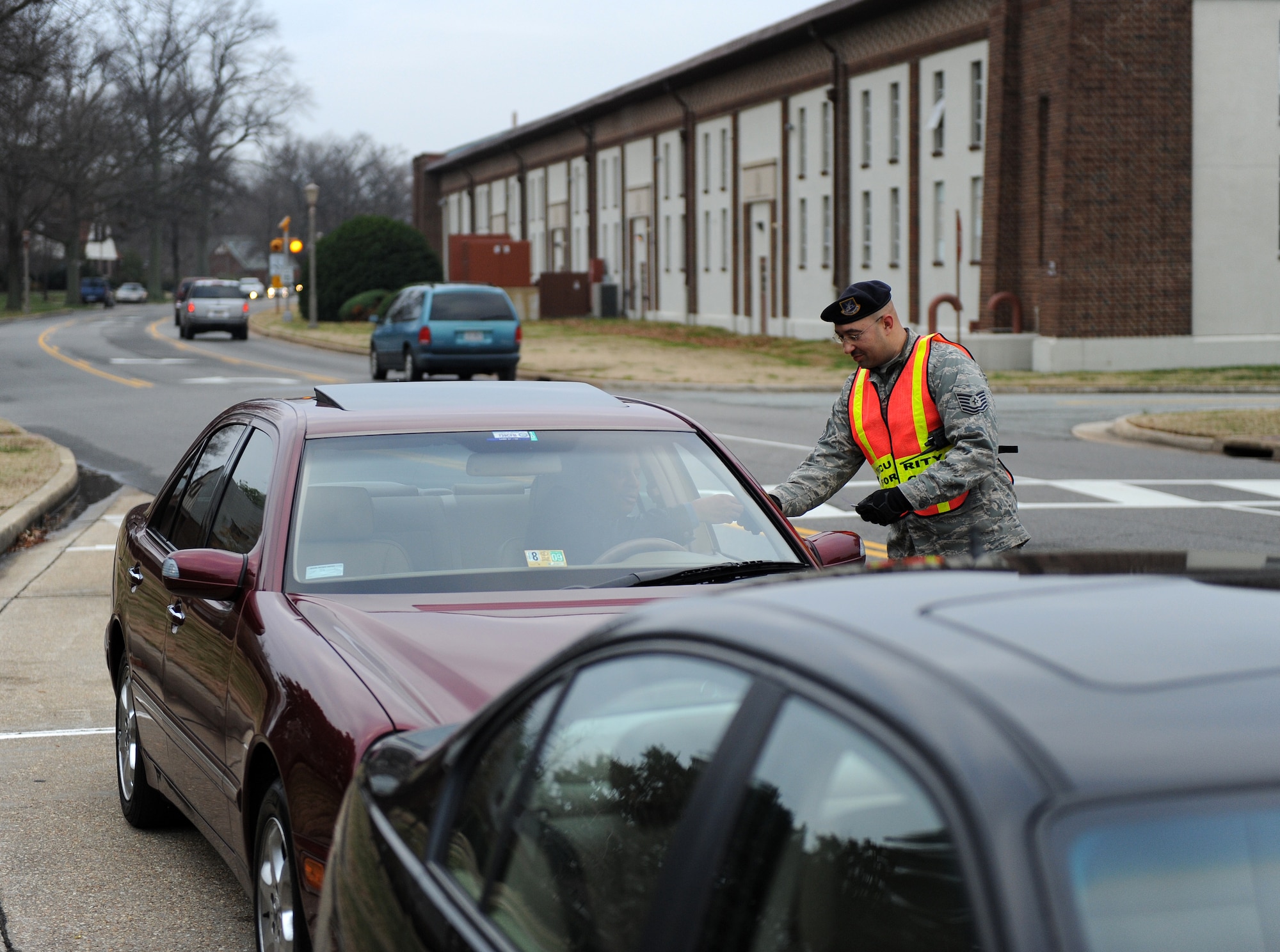 LANGLEY AIR FORCE BASE, Va. – Tech. Sgt. Charles Carter, 1st Security Forces Squadron non-commissioned officer in charge of the armory, asks for a motorist’s license and military identification on Sweeney Boulevard Dec. 18.  Security forces set up observation points in high target areas in order to deter motorists from speeding.  (U.S. Air Force photo/Airman 1st Class Zachary Wolf)