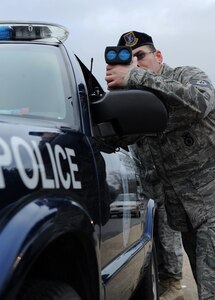 LANGLEY AIR FORCE BASE, Va. – Tech. Sgt. Stephen Springer, 1st Security Forces Squadron unit deployment manager, checks the speed of oncoming vehicles on Sweeney Boulevard Dec. 18.  Security forces  set up observation points in high target areas in order to deter motorists from speeding.  (U.S. Air Force photo/Airman 1st Class Zachary Wolf)