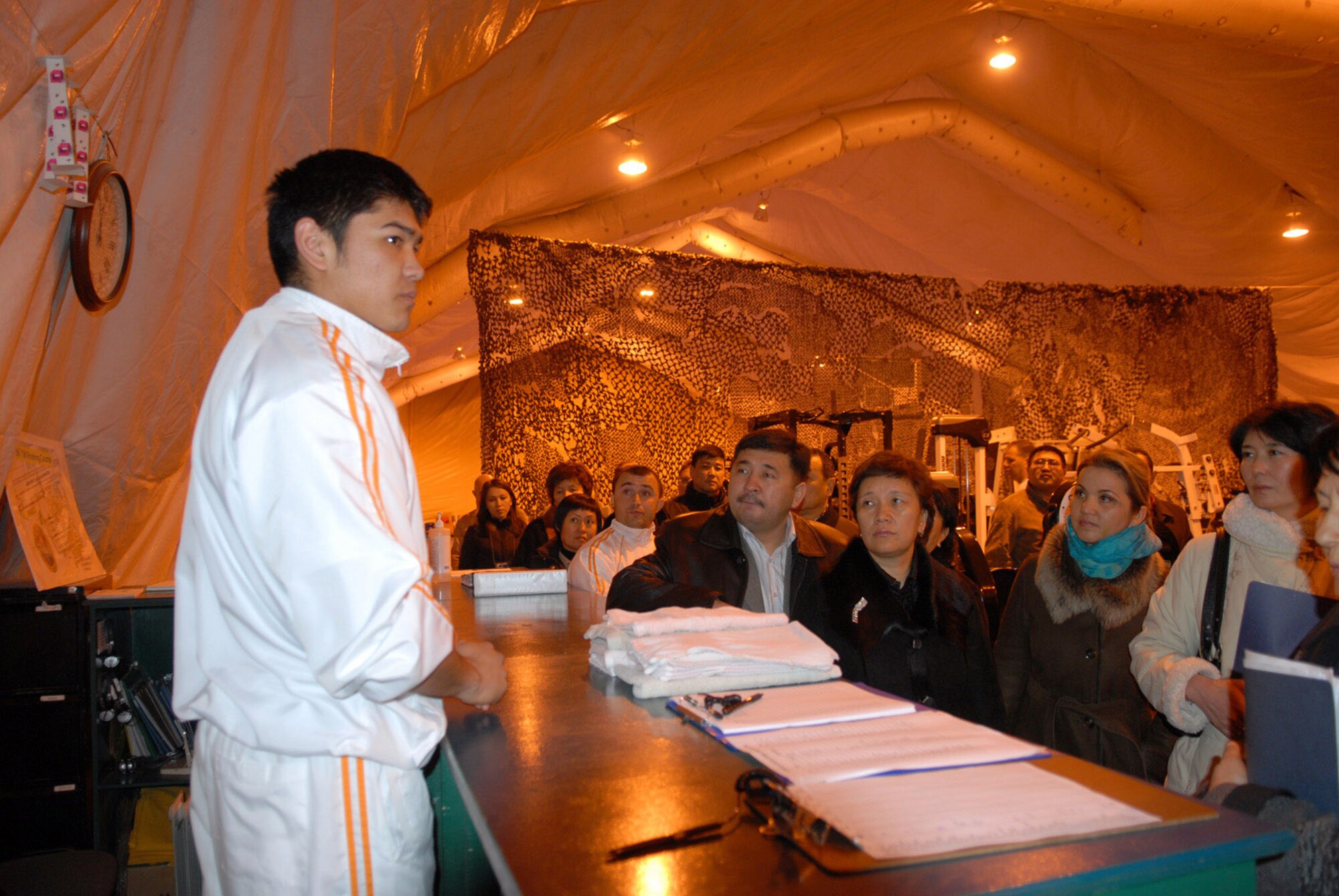 Timur Seidaliev explains his duties and experiences as a Kyrgyz employee on base to members of the Kyrgyz parliament during a Dec. 15 visit to Manas Air Base, Kyrgyzstan. Mr. Seidaliev is the fitness center event coordinator. (U.S. Air Force photo/Senior Airman Ruth Holcomb) 
