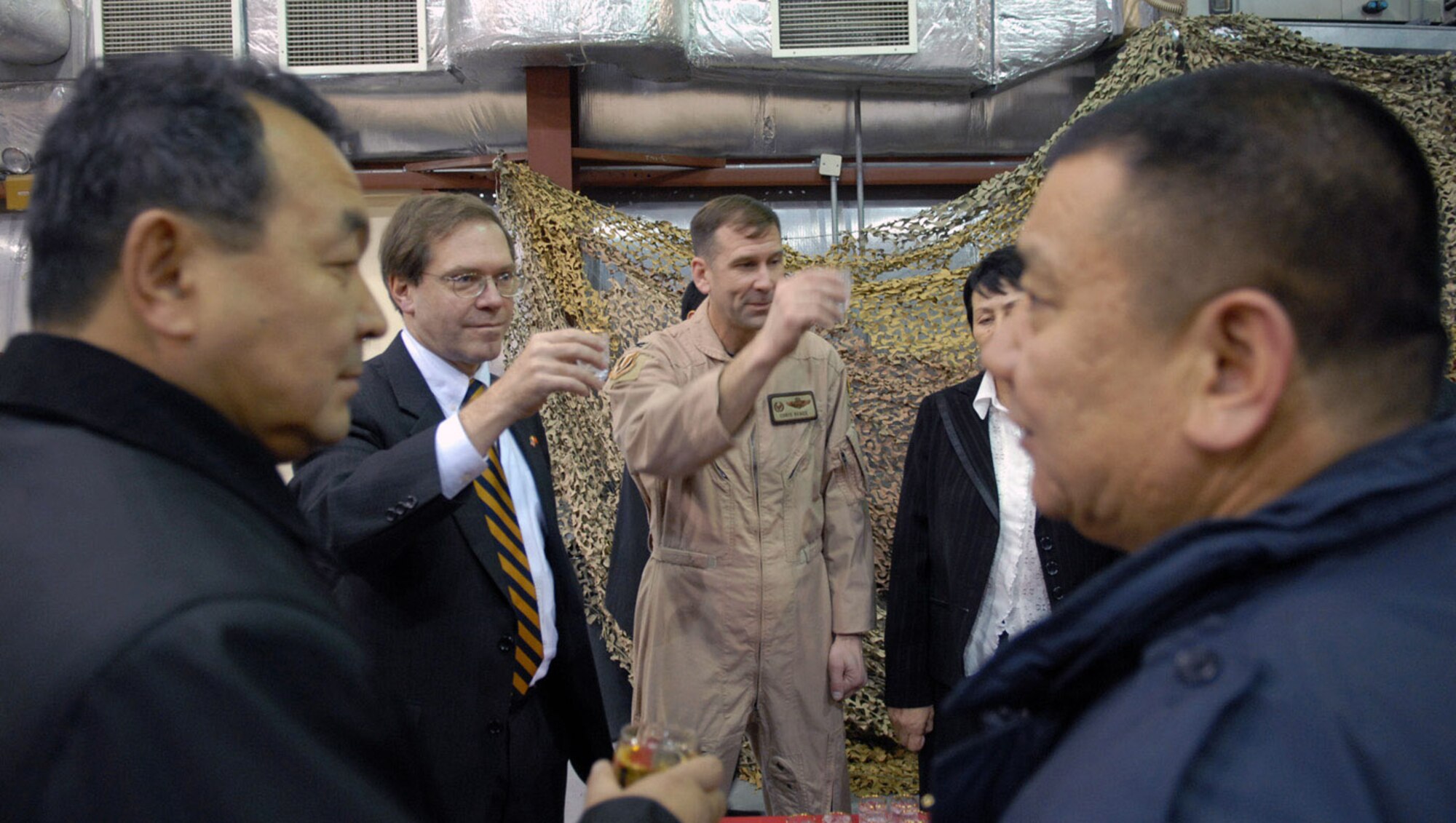 Col. Christopher Bence and Lee Litzenberger offer a toast to members of the Kyrgyz parliament during a during a Dec. 15 visit to Manas Air Base, Kyrgyzstan. Colonel Bence is the 376th Air Expeditionary Wing commander, and Mr. Litzenberger is the deputy chief of mission at the U.S. Embassy to Kyrgyzstan. (U.S. Air Force photo/Senior Airman Ruth Holcomb) 
