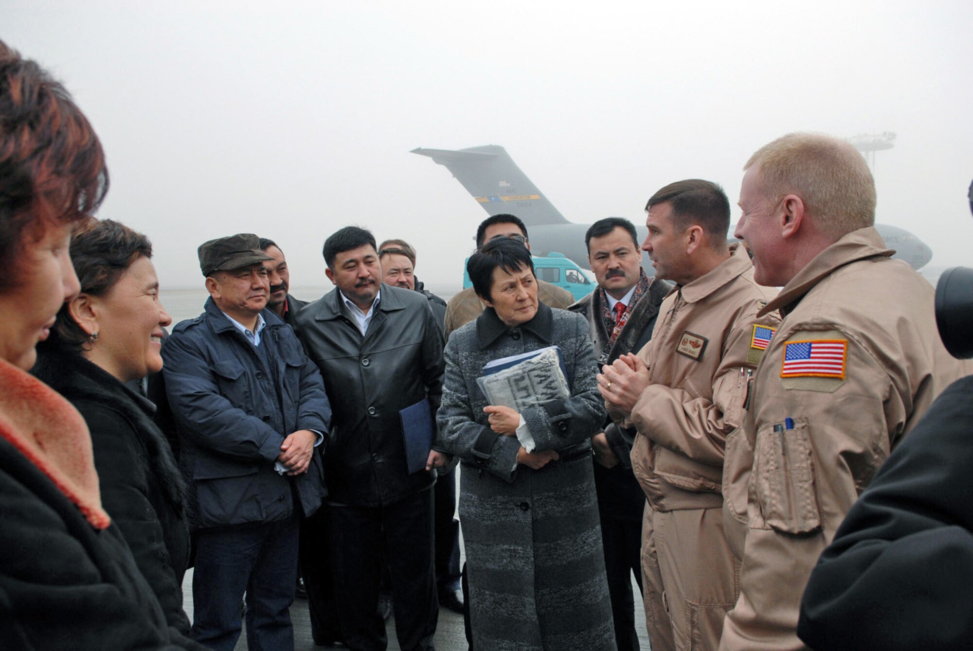 Col. Christopher Bence and Senior Master Sgt. Steven Flax respond to question from members of the Kyrgyz parliament about the KC-135 Stratotanker during a Dec. 15 visit to Manas Air Base, Kyrgyzstan. Colonel Bence is the 376th Air Expeditionary Wing commander, and Sergeant Flax is the 376th Expeditionary Operations Group superintendent. (U.S. Air Force photo/Senior Airman Ruth Holcomb) 
