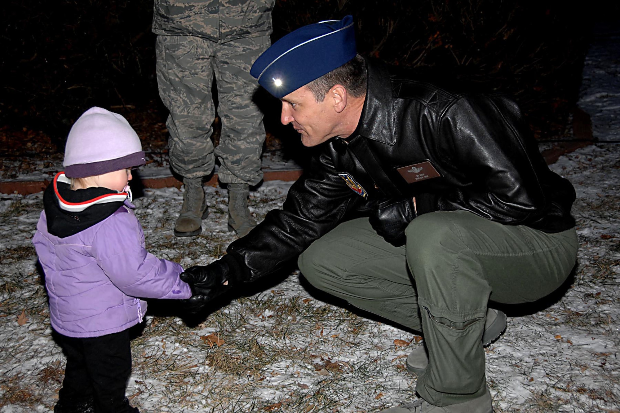 OFFUTT AIR FORCE BASE, Neb. -- Brig. Gen. James J. Jones, 55th Wing commander, takes time after the officail HolidayTree Lighting Ceremony Dec. 4 at the Strategic Air Command Memorial Chapel to say hello to Rebecca Kurinec, daughter of Maj. Christopher Kurinec, 55th Aerospace Medicine Squadron, Bioenvironmentalist and Vicky Kurinec. Children watched the Holiday Tree being lit, and then got to spend some time with Santa Clause at the Community Center.  (U.S. Air Force Photo By Kensra Williams)