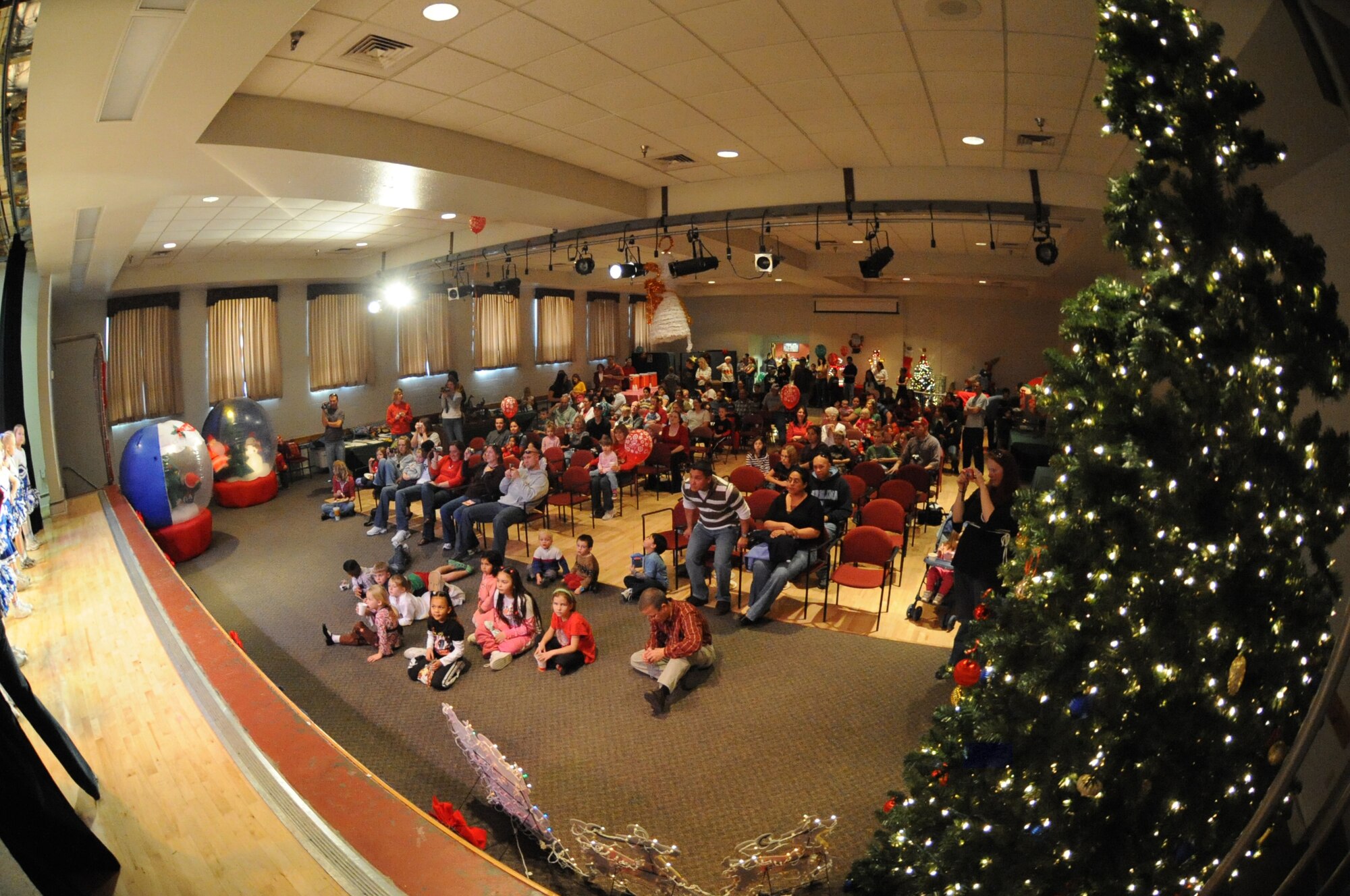 Members of the audience watch as the Holloman cheerleaders give a performance during the International Children's Festival at the Community Center at Holloman Air Force Base, N.M., Dec. 13. The festival was created to give children a look at diverse Air Force families and their holiday traditions.  More than 650 people attended. (U.S. Air Force photo/Airman 1st Class Sondra Escutia)
