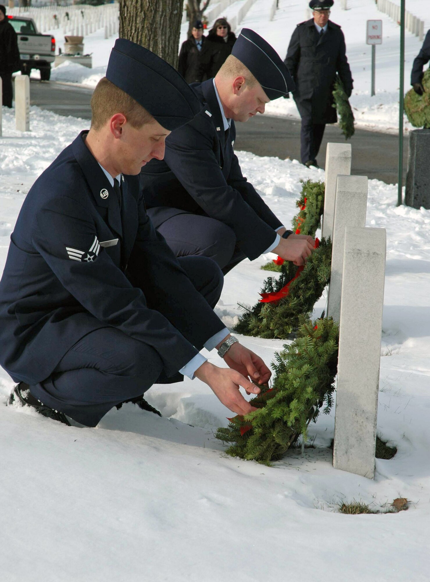Senior Airman Justin Gort (left) and 1st Lt. Brandon Schrader lay wreaths Dec. 13 at Fort Snelling National Cemetery, Minn. The two are assigned to the 96th Airlift Squadron from the 96th Airlift Squadron from the Minneapolis-St. Paul Joint Reserve Station in Minnesota. (U.S. Air Force photo/Capt. S.J. Brown) 
