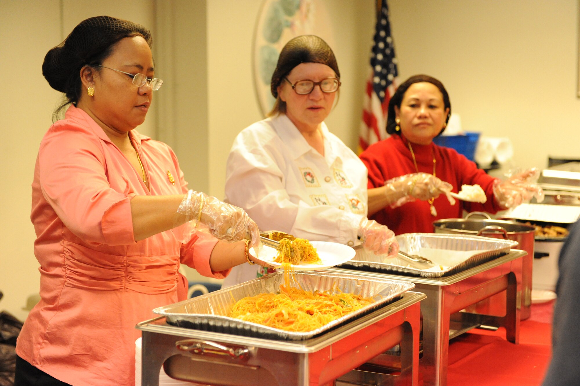 Members of the Asian Pacific Islanders Club serve their traditional food during the International Children's Festival at the Community Center at Holloman Air Force Base, N.M., Dec. 13. This was one of the stops children made throughout the festival which showcased many different country's holiday traditions. Other stations included a German pastry shop and a Kwanzaa presentation by the African American Heritage Committee. (U.S. Air Force photo/Airman 1st Class Sondra Escutia)