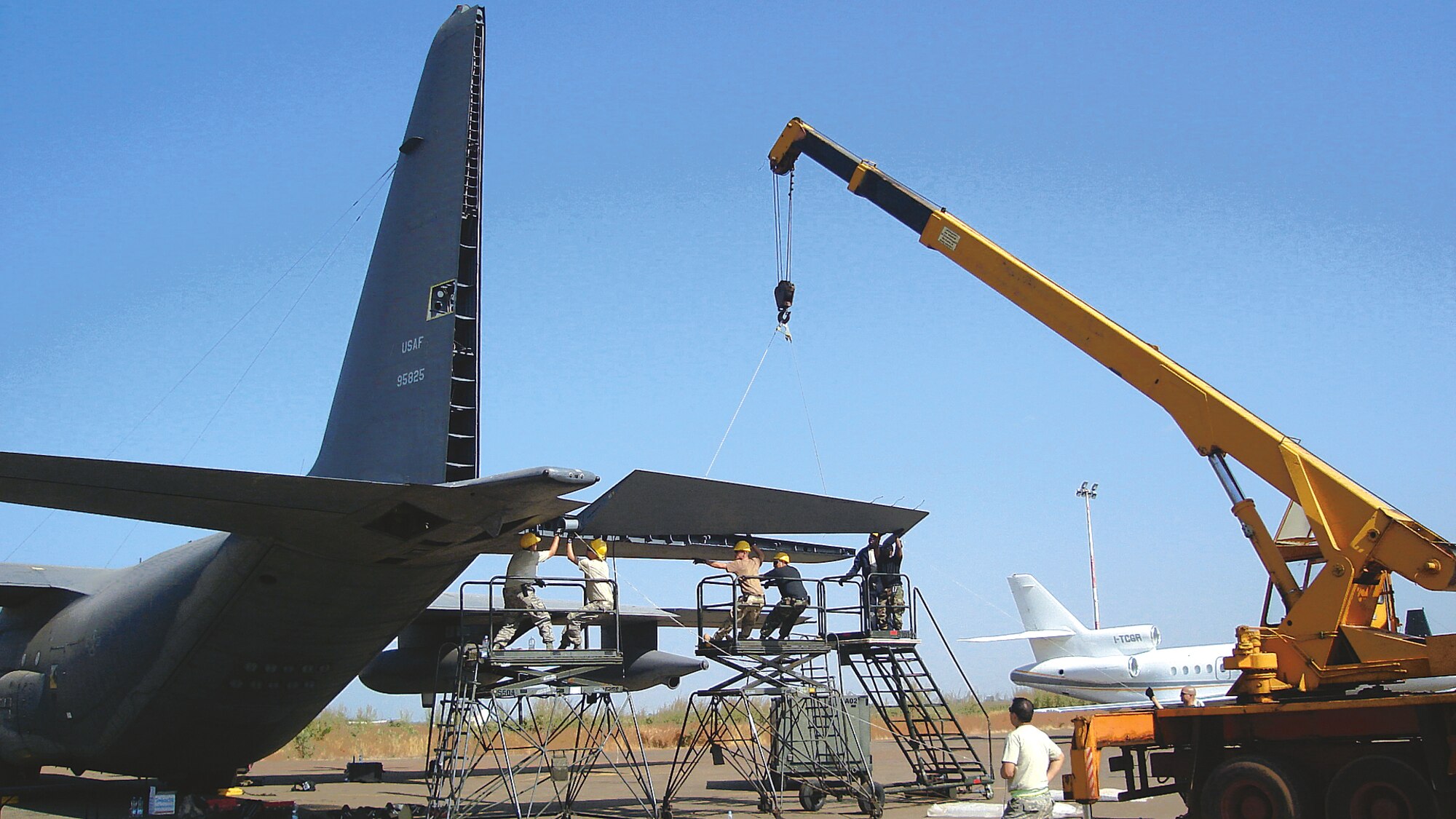 Members of the 653rd Combat Logistics Support Squadron replace the elevator on the tail section of a severely damaged  MC-130P in Bamako, Mali in November. courtesy photo   