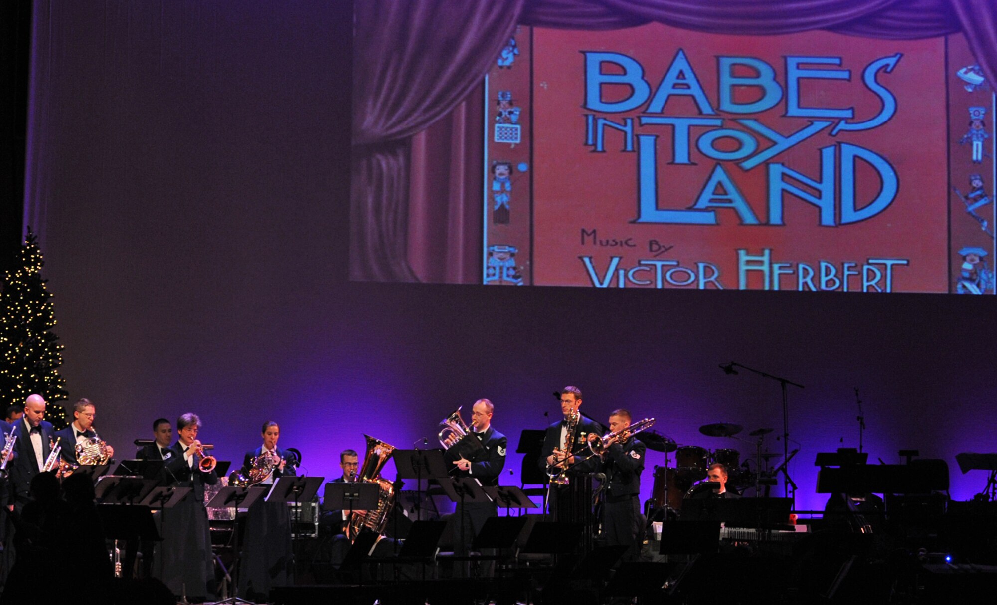 Members of the Heartland of America Band perform the theme to "Babes in Toyland" during  "The Promise of the Season" holiday concert at the Holland Performing Arts Center Dec. 12. A special concert was performed for children from the local area schools.  (U.S. Air Force Photo By Jeff Gates)