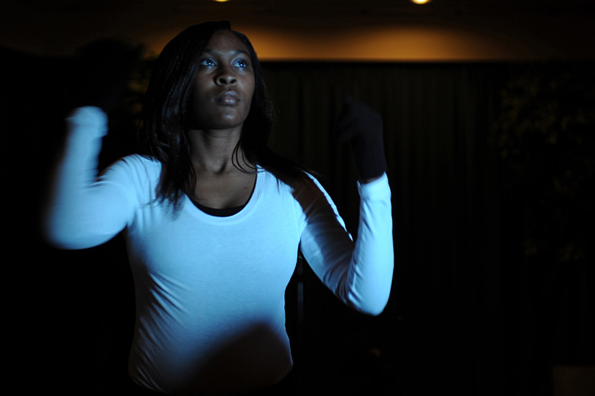 DYESS AIR FORCE BASE, Texas -- Airman First Class Xanthea Moore, from the 7th Force Support Squadron, performs a praise dance to "I Need You to Survive" by Kirk Franklin during the Family and Teen Talent Contest at the Hangar Center here, Dec. 17. All contest winners are videotaped and sent up to Air Force level to compete in the Air Force Family and Teen contest. (U.S. Air Force photo/Senior Airman Courtney Richardson)
