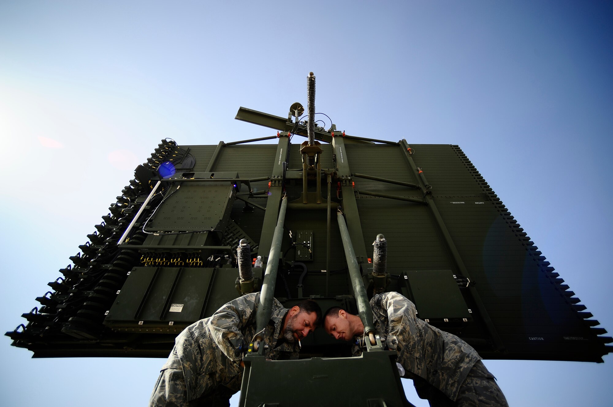 Stephen Varnagy and Staff Sgt. Christopher Loper apply grease to an antenna bearing at Joint Base Balad, Iraq, Dec. 18. Greasing the bearing prevents corrosion and reduces friction on the radar antenna. Varnagy and Loper are deployed to the 727th Expeditionary Air Control Squadron from Mountain Home Air Force Base, Idaho. Varnagy's hometown is Boise, Idaho. Loper's hometown is Houston. (U.S. Air Force photo/Airman 1st Class Jason Epley)(Released)