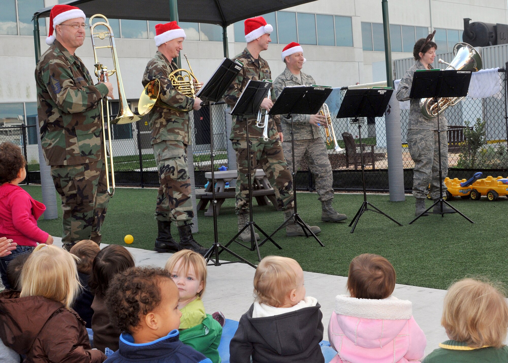 Members of the Travis Brass Quintet, a component of the Band of the Golden West, perform holiday music for the children at the Child Development Center on Los Angeles AFB during their tour, Dec. 16. (Photo by Atiba Copeland)

