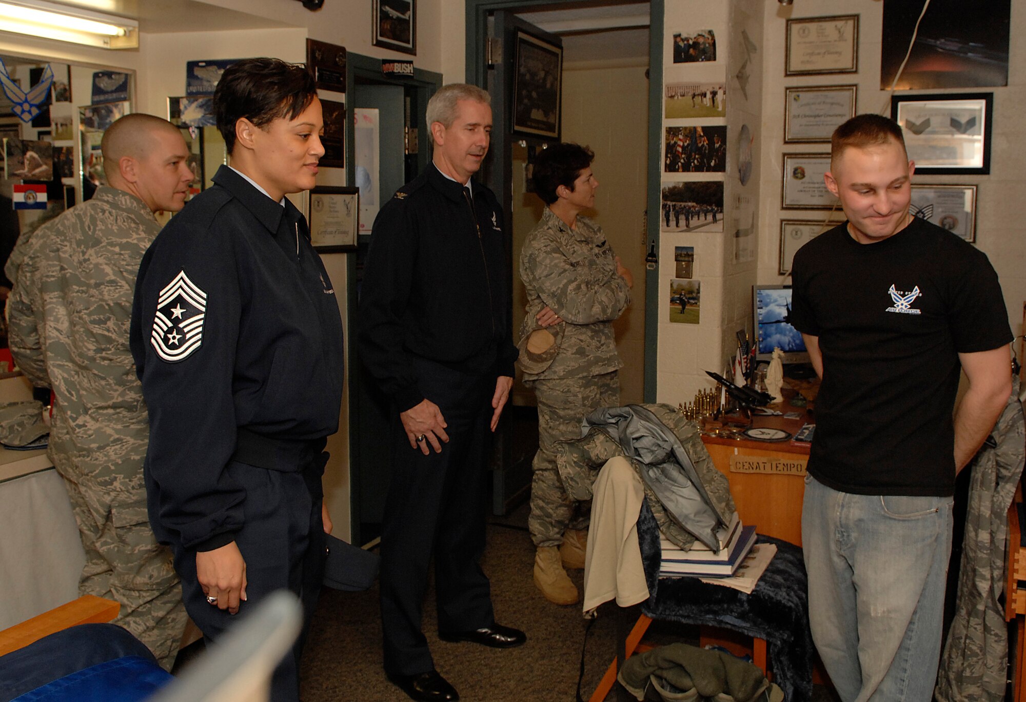 Senior Airmen Chris Cenatiempo, U.S. Air Force Honor Guard, shows members of the 11th Wing leadership items in his dorm room on Bolling AFB. Senior Leadership visited the dorms to deliver cookies to the Airmen as part of the annual Commander’s Cookie Caper sponsored by the Wing and the Air Force Officers Wives Club  (U.S. Air Force photo by Senior Tim Chacon)(Released)