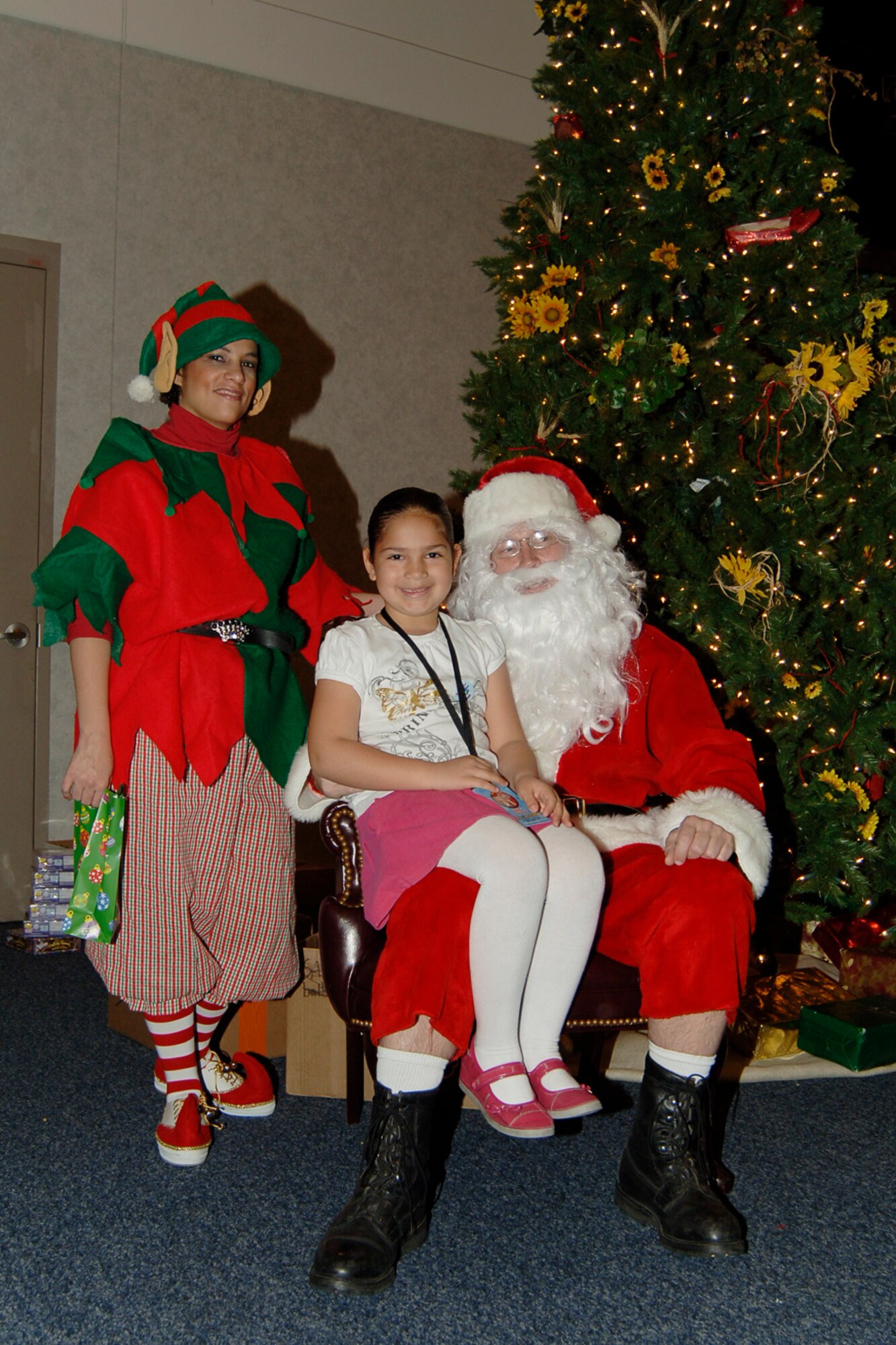 MCCONNELL AIR FORCE BASE, Kan. – Desiree Withington, daughter of Airman 1st Class Maria Ruiz, 22nd Air Refueling Wing, poses for a photo with Santa during his visit to the Dole Center, Dec. 13. The event offered Team McConnell children an opportunity to tell Santa what they wanted for Christmas and take home a photo. (Photo by Airman 1st Class Maria Ruiz)