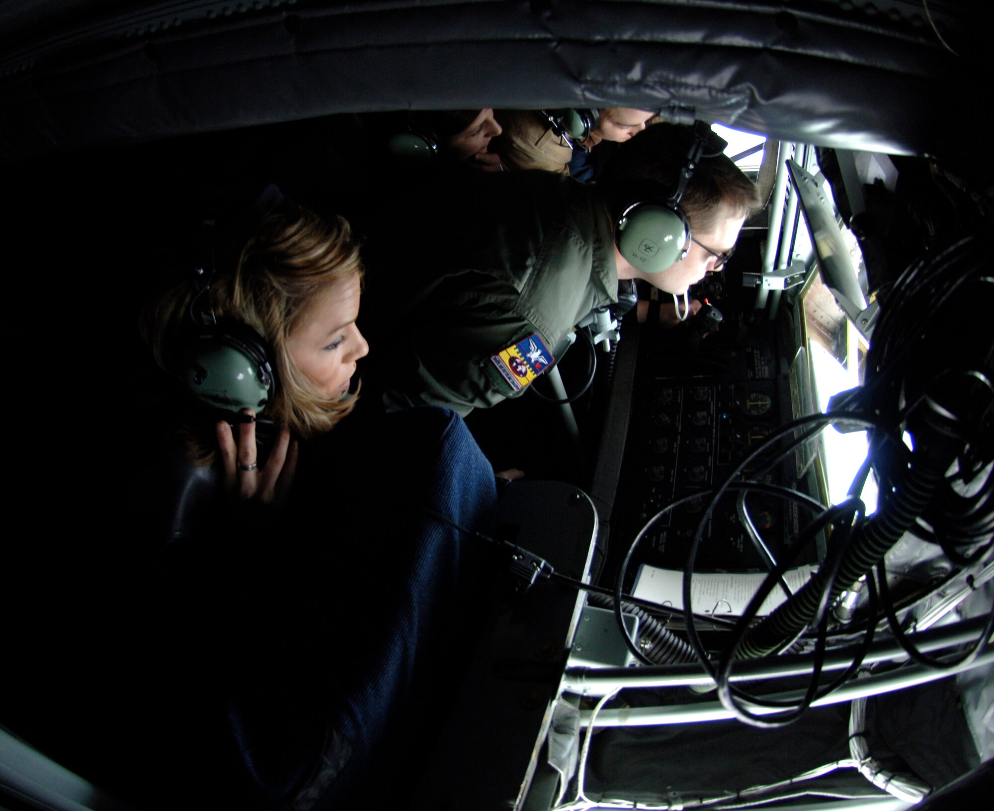 MCCONNELL AIR FORCE BASE, Kan. – Kelly Aldridge, wife of Capt. Stephen Aldridge, 349th Air Refueling Squadron, looks out the window of a KC-135 Stratotanker boom pod, Dec. 13, during an aerial refueling mission. Military spouses were given the opportunity to fly on the tanker training mission and better understand McConnell’s role in the Air Force. (Photo by Senior Airman Laura Suttles)