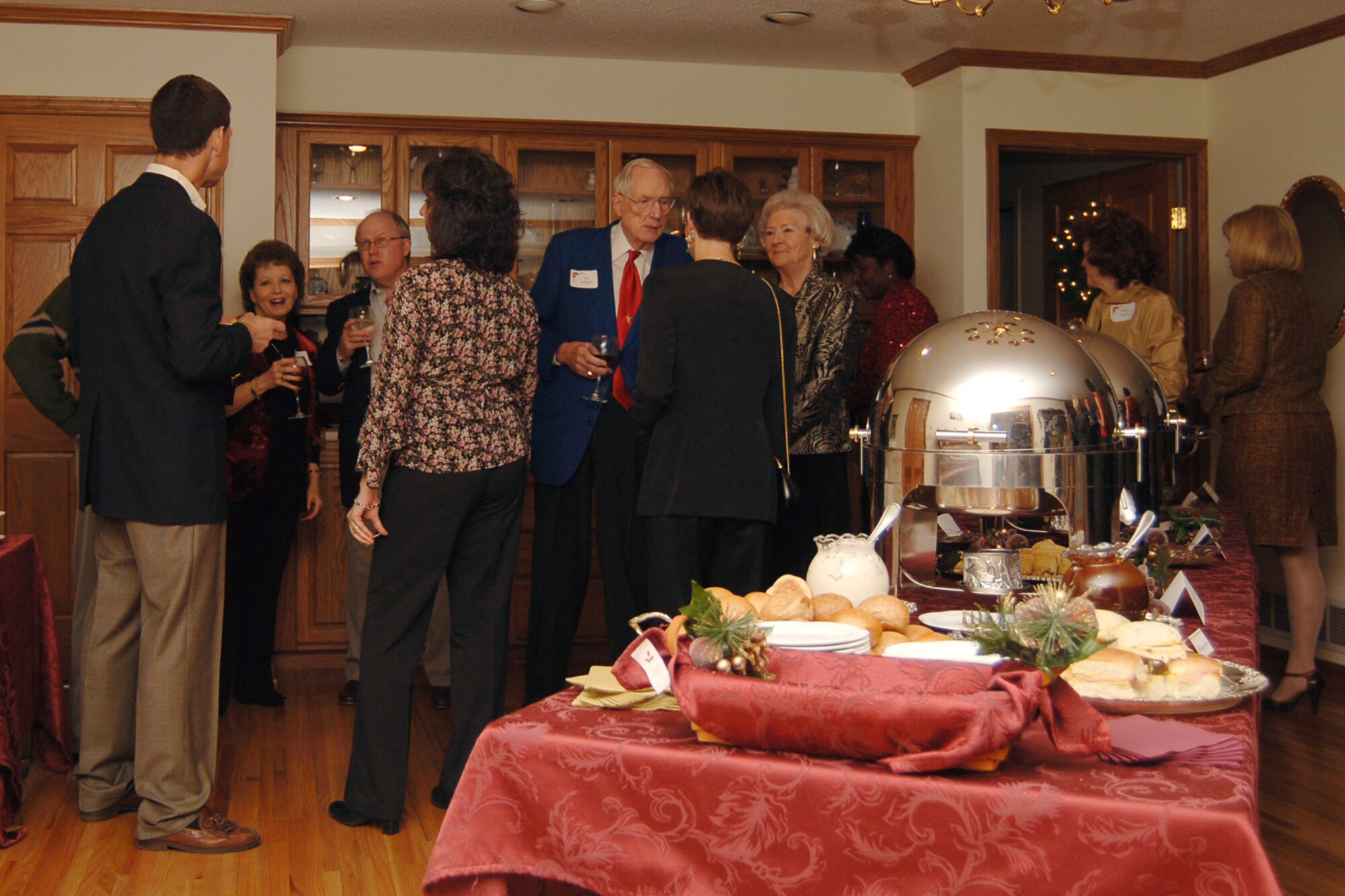 MCCONNELL AIR FORCE BASE, Kan. -- Team McConnell leaders, distinguished visitors and Airmen and thier families gather, Dec. 13, at the home of 22nd Air Refueling Wing Commander Col. James Vechery for the annual base commander’s holiday party. (Photo by Airman 1st Class Maria Ruiz)
