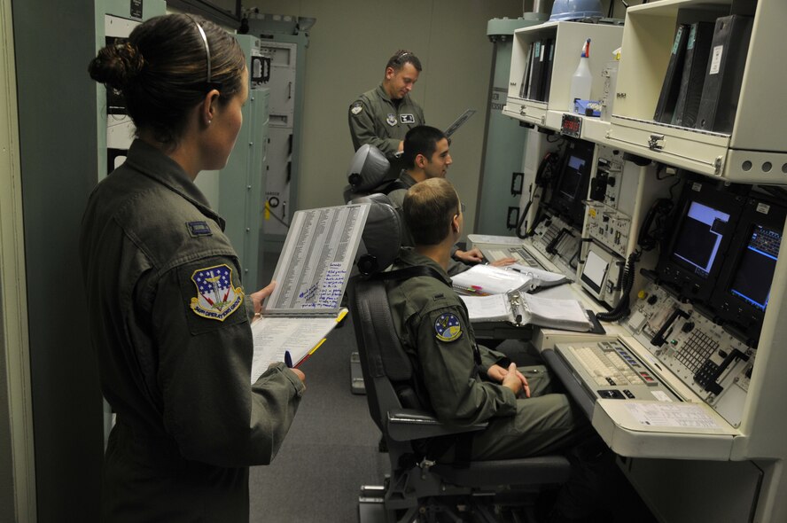 Missileers train in the Missile Procedures Trainer while two 341st Operations Group evaluators look on. (U.S. Air Force Photo/John Turner)