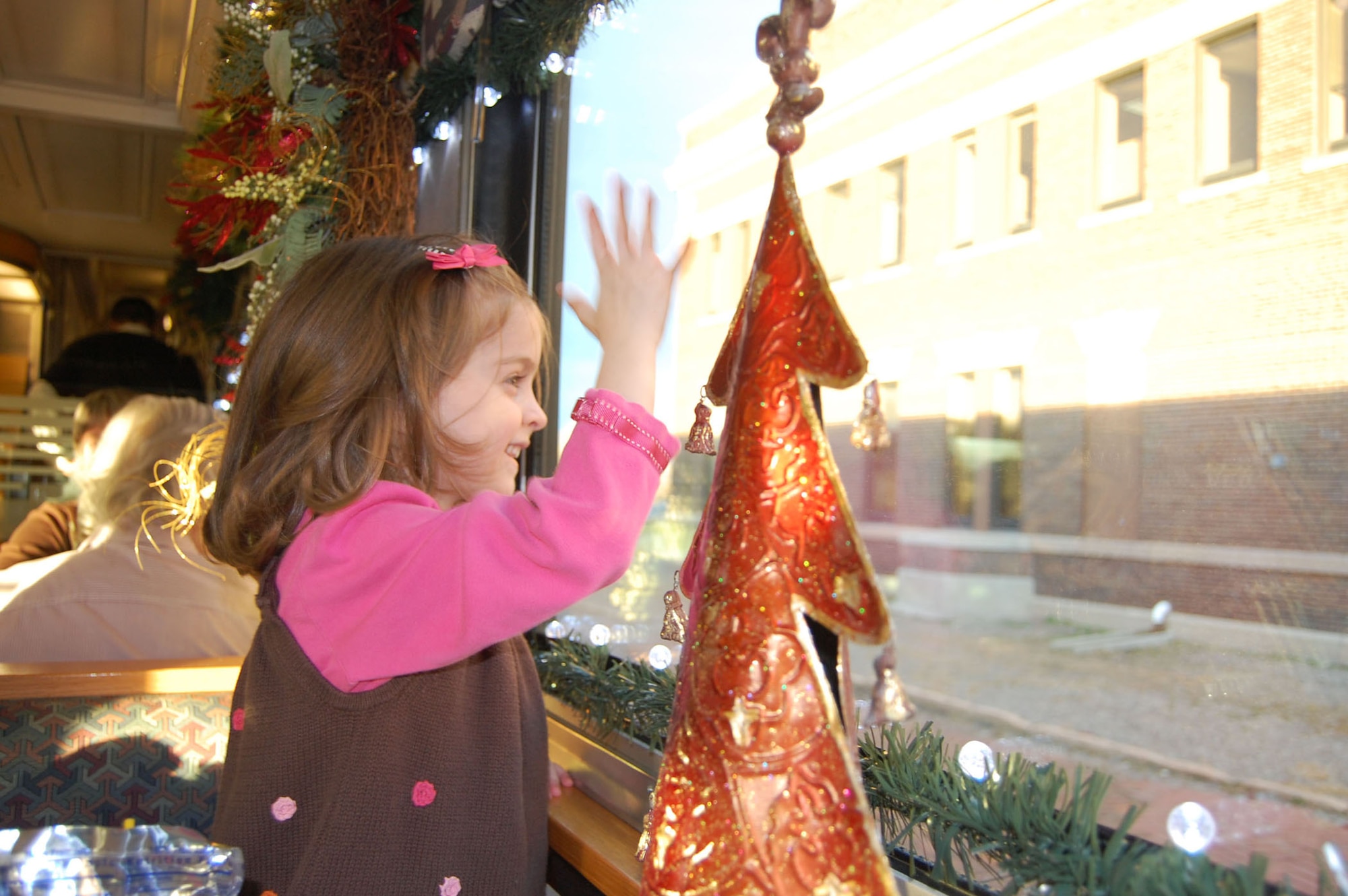 Kiley Leverett, 5, waves as the Holiday Express train begins its journey Dec. 10.  BNSF organized the Holiday Express to recognize the service of military members and their families during the holiday season. (U.S. Air Force photo/1st Lt. Korry Leverett)