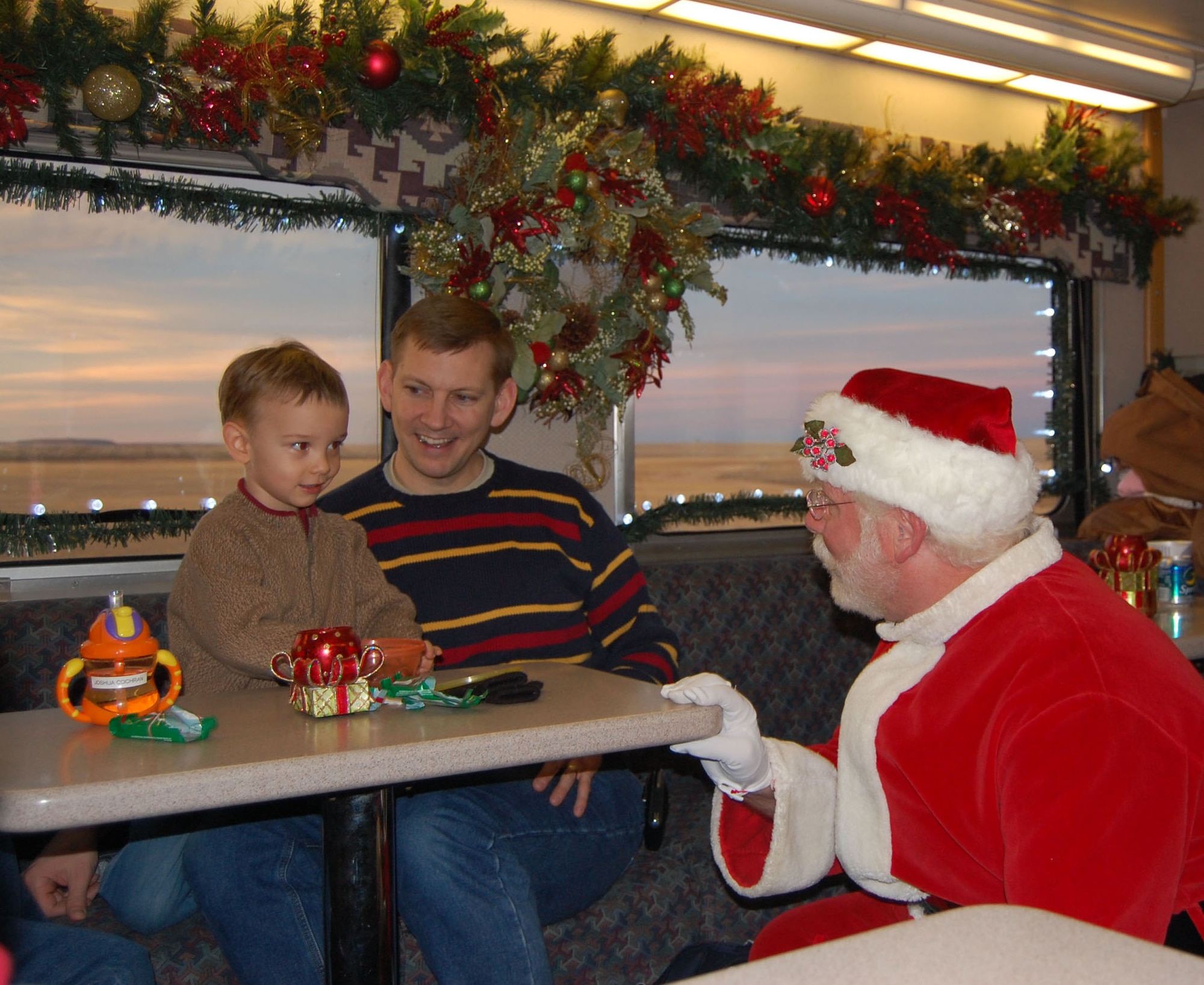 Maj. Jordon Cochran and his son Joshua, 3, greet Santa Claus aboard the Holiday Express train Dec. 10.  BNSF Railways organized the Holiday Express to recognize the service of military members and their families this holiday season. (U.S. Air Force photo/1st Lt. Korry Leverett)