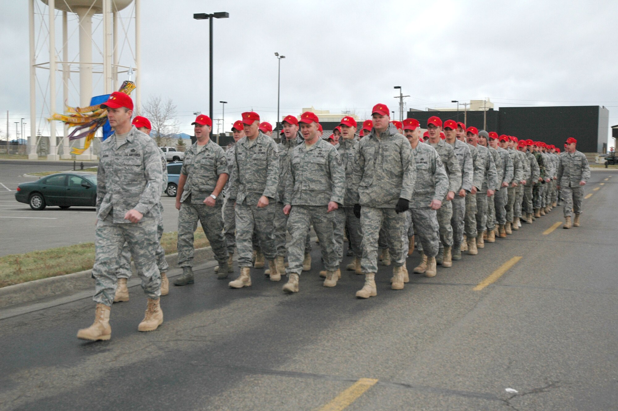 Col. Terry Watkins, 819th RED HORSE Squadron commander, leads a formation of his troops in a road March from their headquarters building to the Grizzly Bend Club Dec. 12. The group held a meeting and then ended their work week enjoying each other's company. (U.S. Air Force photo/Staff Sgt. Eydie Sakura)
