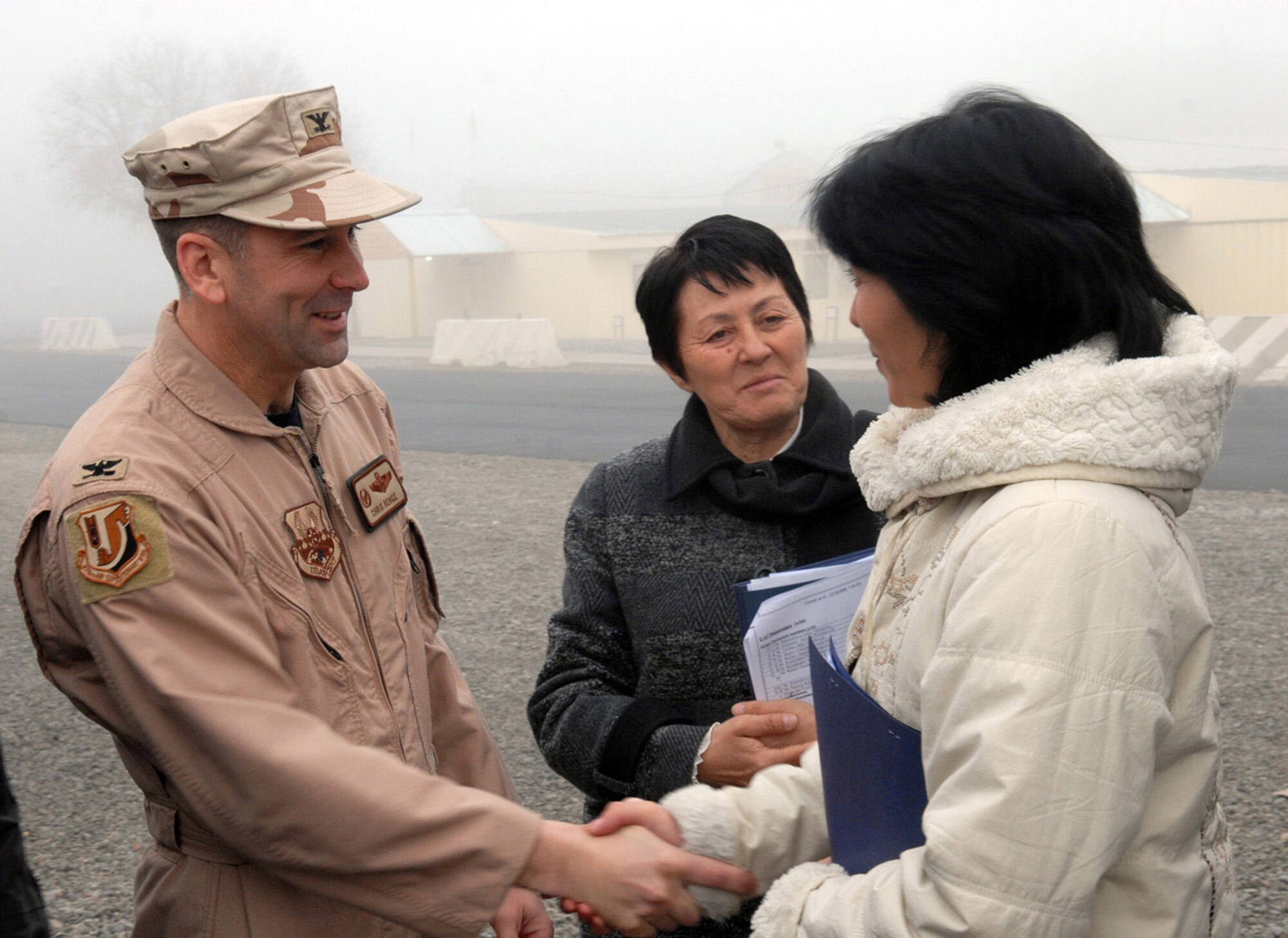 Col. Christopher Bence welcomes a member of the Kyrgyz parliament to a mission briefing during a Dec. 15 visit to Manas Air Base, Kyrgyzstan. Colonel Bence is the 376th Air Expeditionary Wing commander. (U.S. Air Force photo/Senior Airman Ruth Holcomb) 

