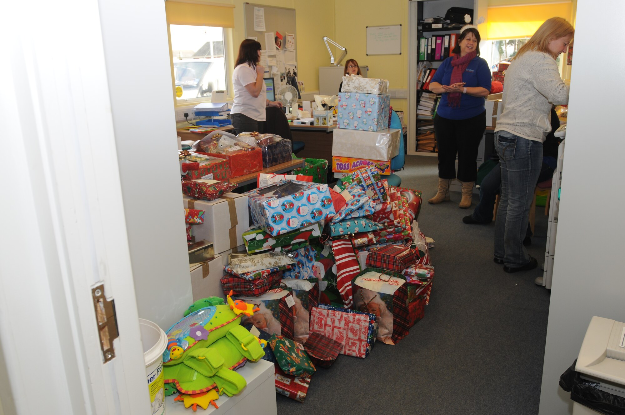 The Sure Start Children’s Centre office is overwhelmed with presents donated by the 48th Fighter Wing. The Christmas presents were collected over a ten-day period and delivered to the children’s centre Dec. 18. (U.S. Air Force photo by Senior Airman Kristopher Levasseur)
