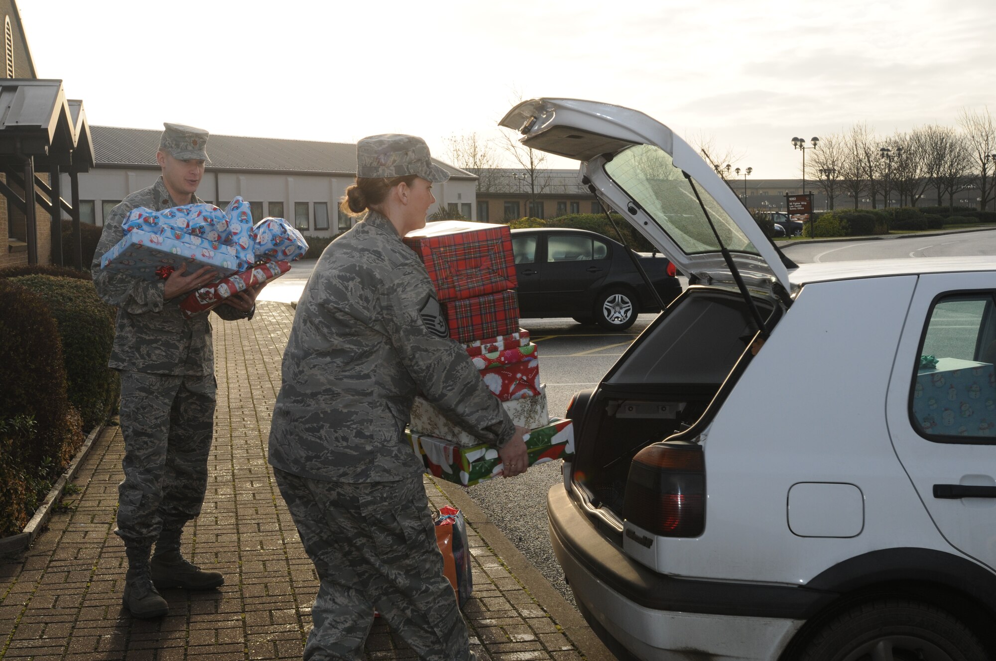 Maj. Christian Lyons, 48th Fighter Wing director of staff assists Master Sgt. Pamela Gacayan, 48th FW commander’s assistant, in loading a car with Christmas presents for the Sure Start Children’s Centre in Thetford. The Christmas presents were collected over a ten-day period and delivered to the children’s centre Dec. 18. (U.S. Air Force photo by Senior Airman Kristopher Levasseur)