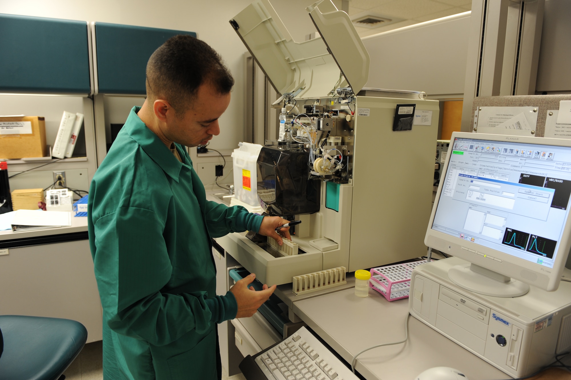 WHITEMAN AIR FORCE BASE, Mo. - Tech. Sgt. Alec Arjona, 509th Medical Group lab technician, operates a hematology analyzer, a new addition in the lab, Dec. 17. The analyzer gives a precise count of white and red blood cells and hemoglobin and will notice any abnormal cells within the test specimen.  This machine is one of the first lines of defense to ensure members of Team Whiteman are healthy. (U.S. Air Force Photo/ Airman 1st Class Carlin Leslie)
