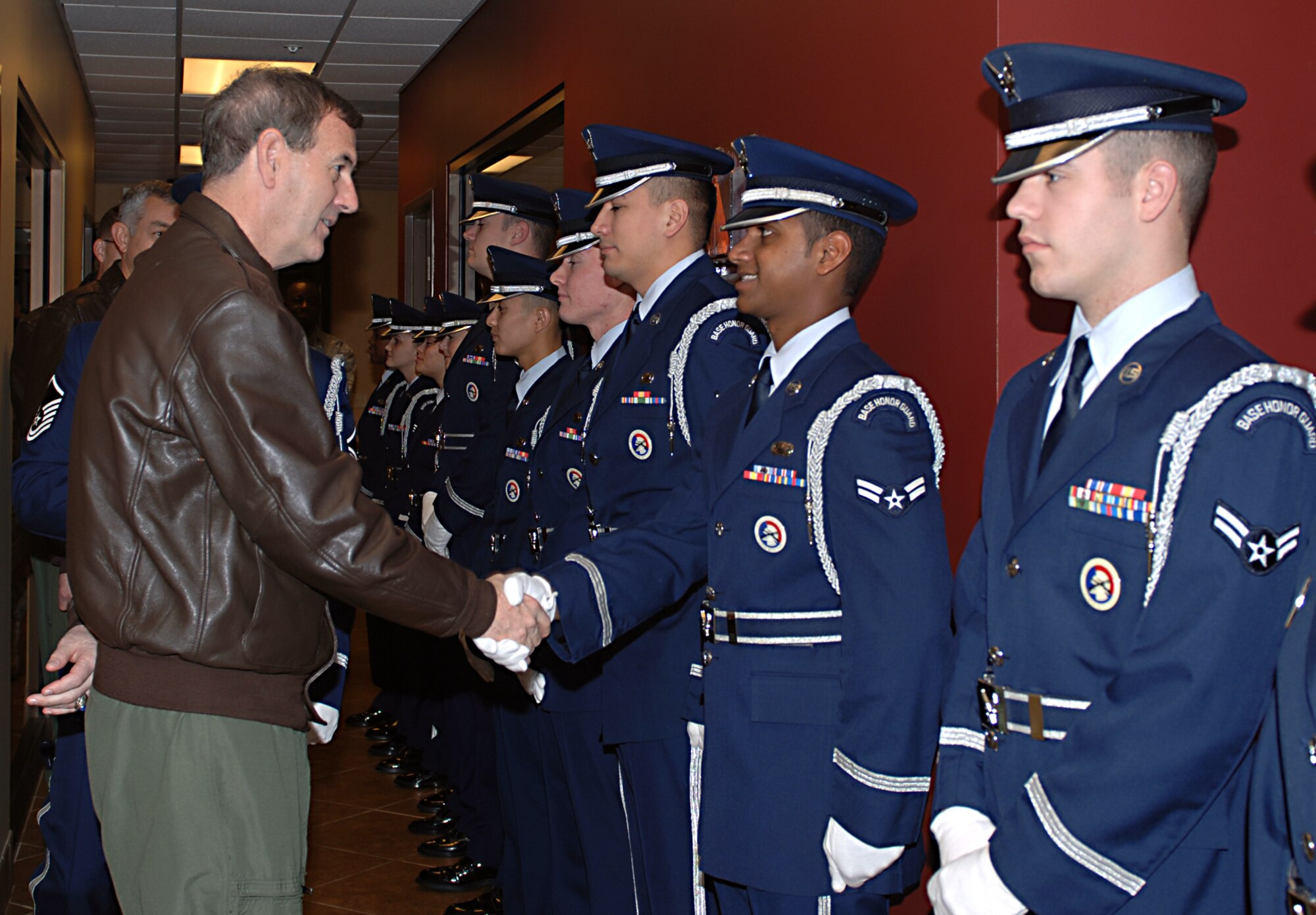 General Stephen Lorenz, Commander, Air Education and Training Command, greets Airman 1st Class Siddharth Sunny, 14th Force Support Squadron, as the Columbus Air Force Base Honor Guard welcomes General Lorenz before a breakfast with dormitory residents in Montgomery Village Tuesday. General and Mrs. Lorenz visited the men and women of Columbus AFB Dec. 15 and 16. (U.S. Air Force photo by Elizabeth Owens)