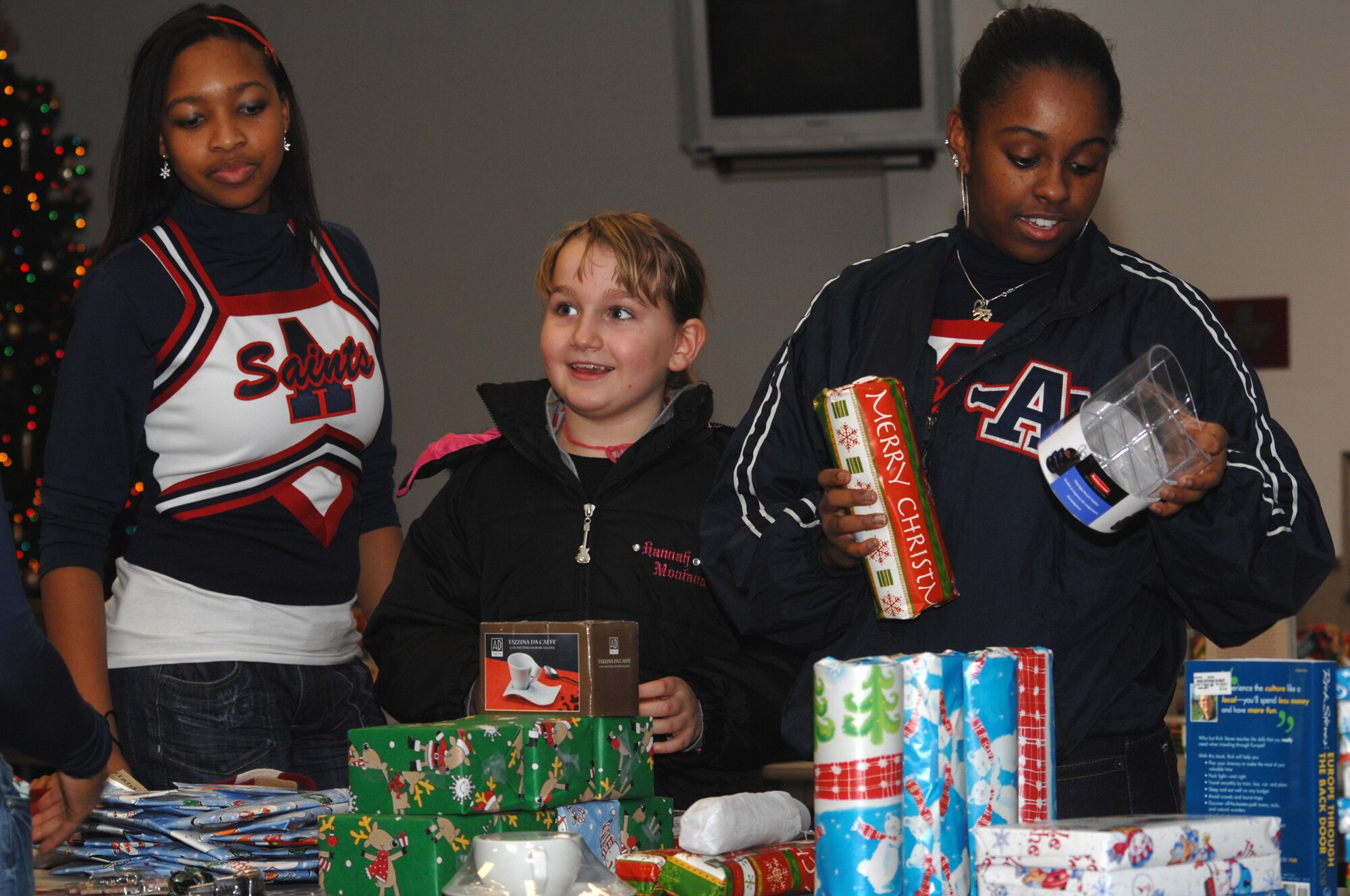 Macey Miller, daughter of Master Sgt. Todd and Stephanie Miller, looks for gifts for her parents and brother, Jackson, during the Aviano Officers and Civilians Spouses Club annual Christmas Cottage Dec. 16 at the Community Center. The cottage, hosted by the AOCSC, allows children to pick out a gift, wrap it and give it to their parents for Christmas. (U.S. Air Force photo/Senior Airman Justin Weaver)