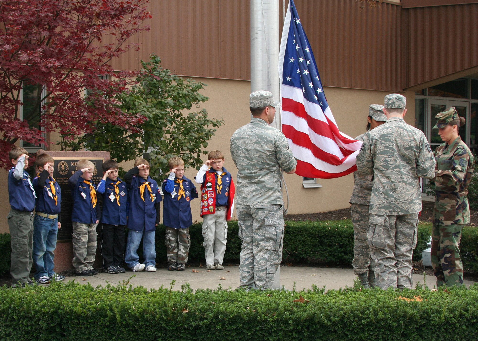PITTSBURGH IAP-ARS -- Cub Scouts from Pack 202 present their traditional two-fingered salute as the base flag is lowered here Nov. 1. The boys took part in the flag retreat ceremony that was conducted by members of the 911th Airlift Wing.  The Cub Scouts is part of the world-wide Scouting movement and is for boys age 8-10. Like the Air Force, Scouting promotes moral fortitude, physical fitness and mental awareness. (U.S. Air Force photo by Tech. Sgt. Ian Carrier)