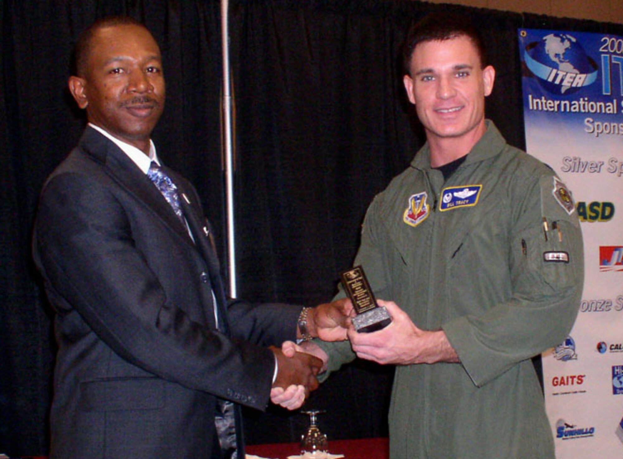 Lt. Col. William Tracy, 59th Test and Evaluation Squadron, accepts the Special Achievement Award from Mr. John Smith, ITEA president at a ceremony in New Jersey last month. (courtesy photo)