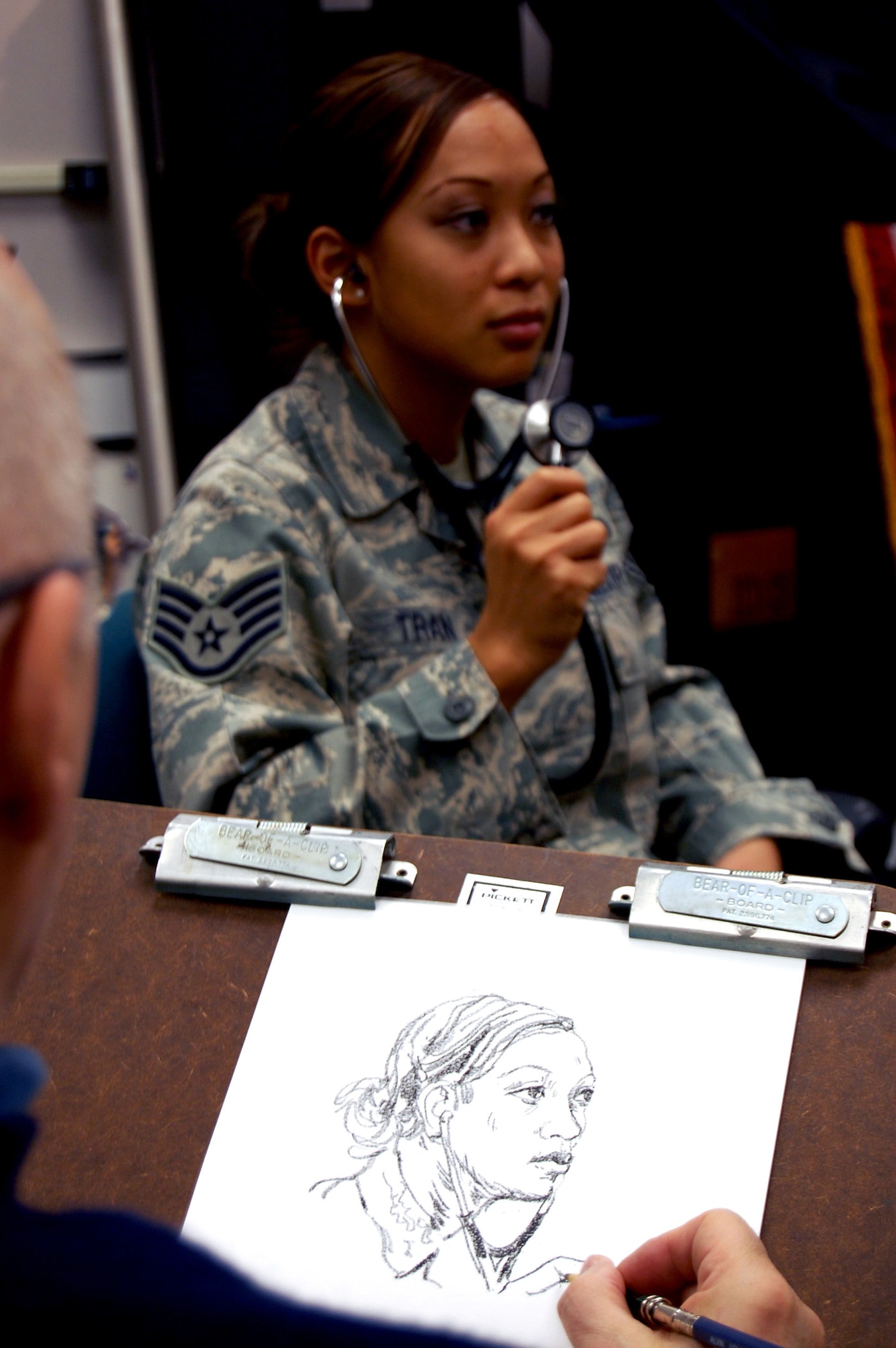 Artist John Witt, chairman of the New York Society Illustrators, makes a sketch of Staff Sgt. Hoang Tran, Mobility Operations School, Dec. 12, 2008, in the U.S. Air Force Expeditionary Center studio on Fort Dix, N.J.  The effort was part of preparatory work by Mr. Witt to complete a painting highlighting Expeditionary Center Airmen for the Air Force Art Program.  (U.S. Air Force Photo/Staff Sgt. Nathan Bevier)