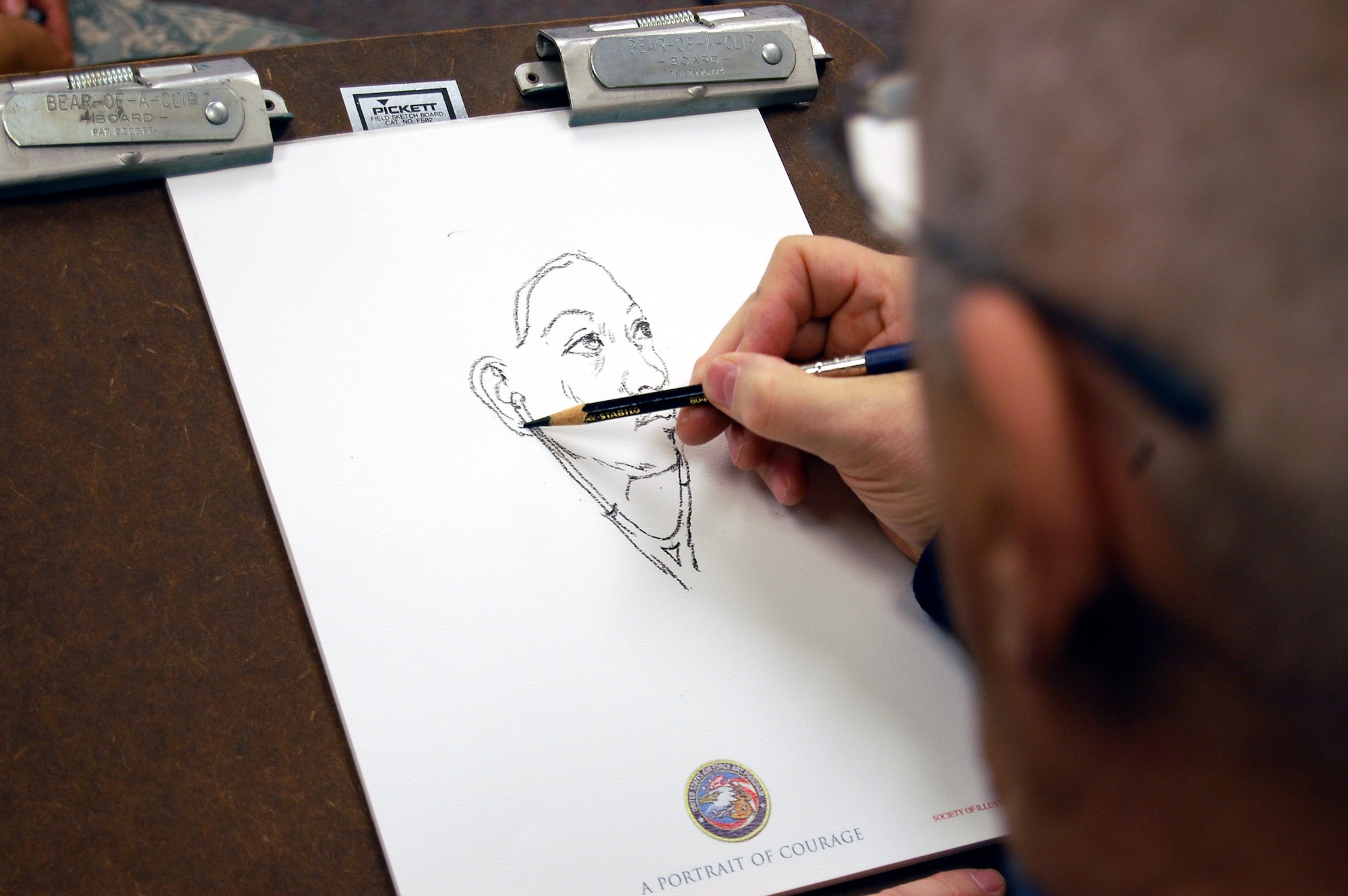 Artist John Witt, chairman of the New York Society Illustrators, makes a sketch of Staff Sgt. Hoang Tran, Mobility Operations School, Dec. 12, 2008, in the U.S. Air Force Expeditionary Center studio on Fort Dix, N.J.  The effort was part of preparatory work by Mr. Witt to complete a painting highlighting Expeditionary Center Airmen for the Air Force Art Program.  (U.S. Air Force Photo/Staff Sgt. Nathan Bevier)