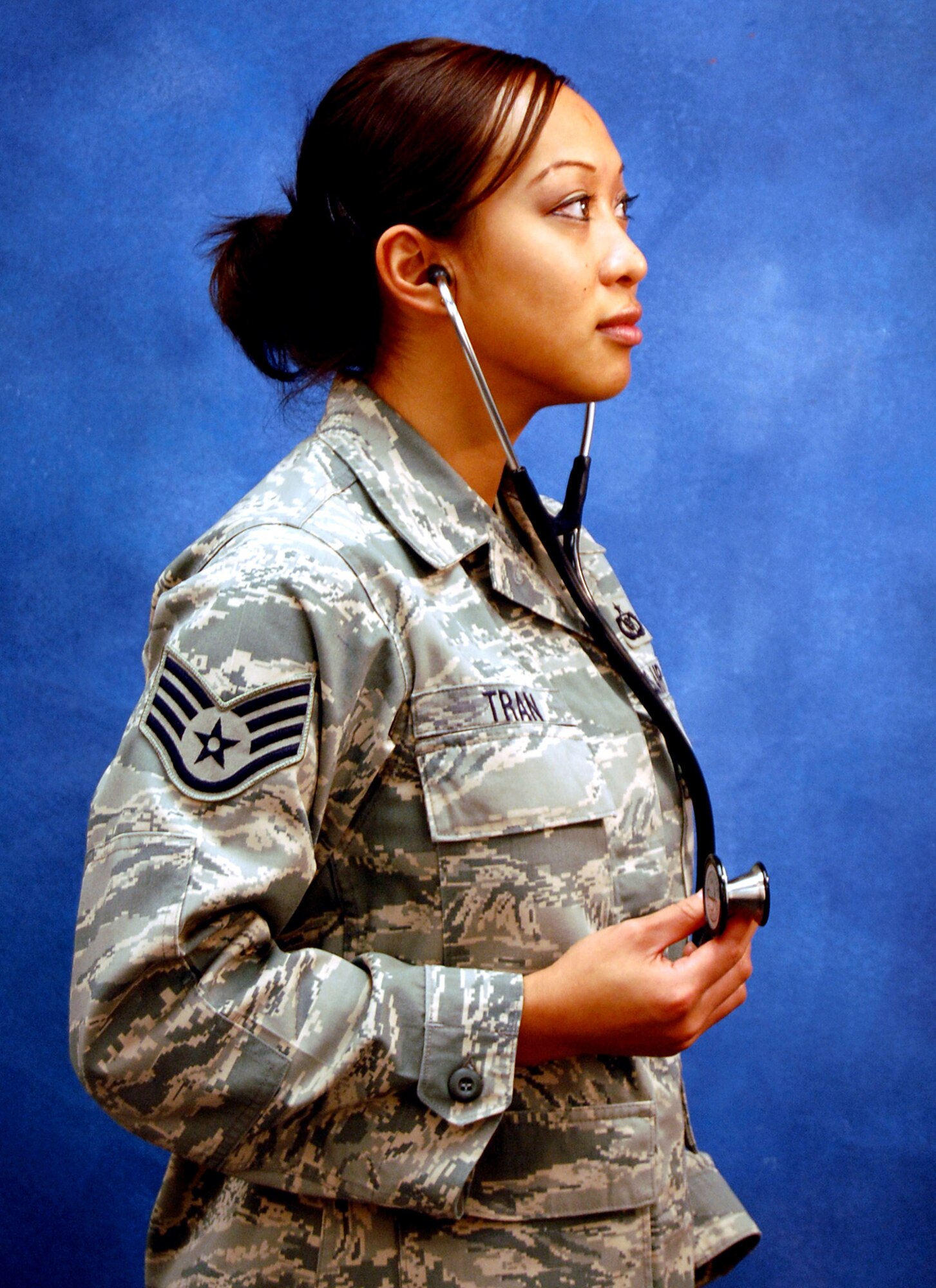 Staff Sgt. Hoang Tran, instructor with the U.S. Air Force Expeditionary Center's Mobility Operations School, models for a photo Dec. 12, 2008, in the Expeditionary Center studio on Fort Dix, N.J.  The effort was part of preparatory work by an artist from the Air Force Art Program to complete a painting highlighting Expeditionary Center Airmen. (U.S. Air Force Photo/Nathan G. Bevier)