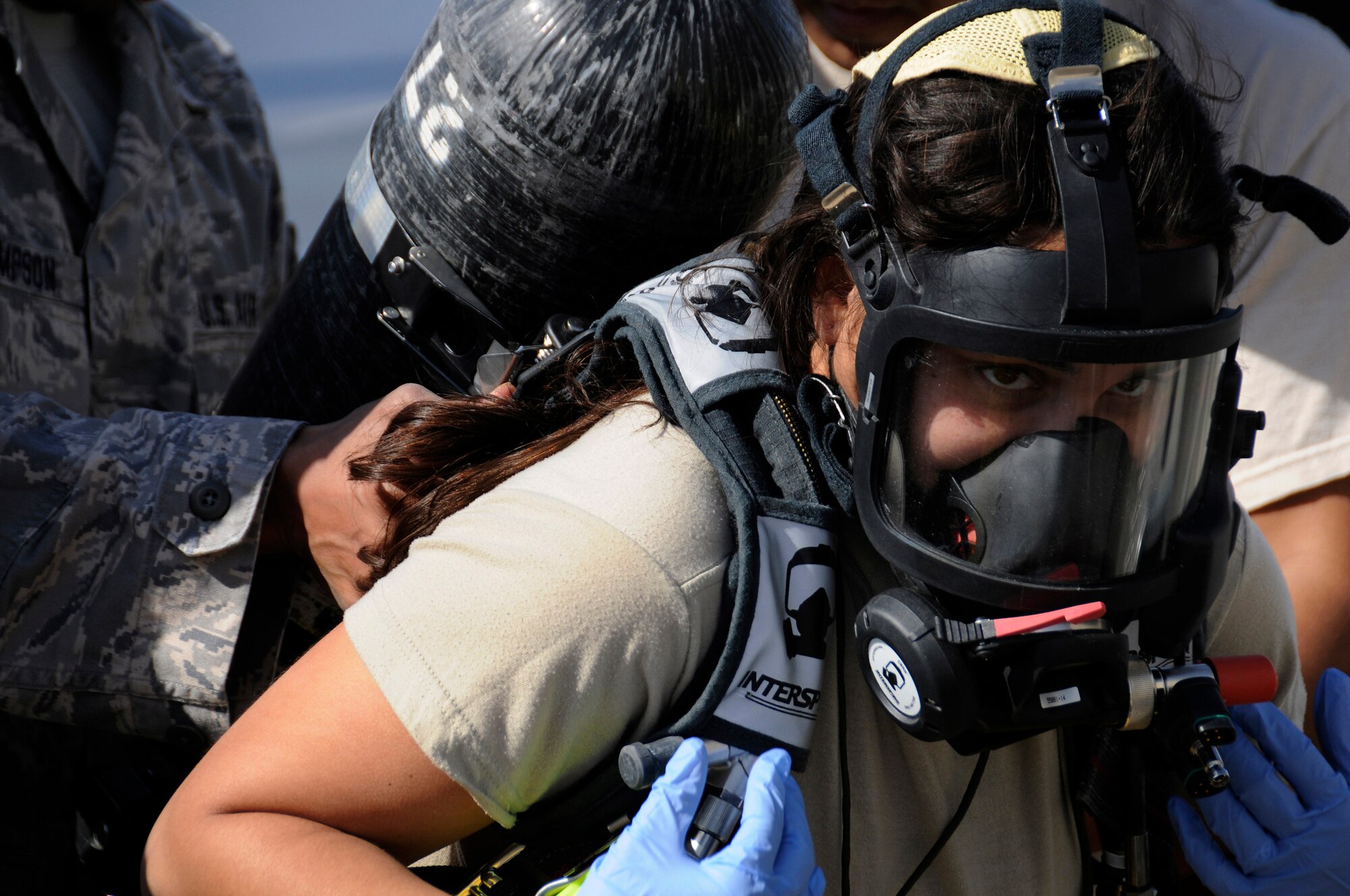 Staff Sgt. Aubrey Pabon, a bioenvironmental engineering technician assigned to the 379th Expeditionary Medical Group, straps on her air tank as the last step before completely sealing her bio suit, Dec. 17, at an undisclosed air base in Southwest Asia.  Suiting up in full bio suits to assess a chemical spill was one of the areas tested during a major accident response exercise.  The MARE also tested security forces, medical and fire department responses.  Sergeant Pabon is deployed from Shaw Air Force Base, S.C. in support of Operations Iraqi and Enduring Freedom and Joint Task Force-Horn of Africa.  (U.S. Air Force photo by Tech. Sgt. Michael Boquette/Released)