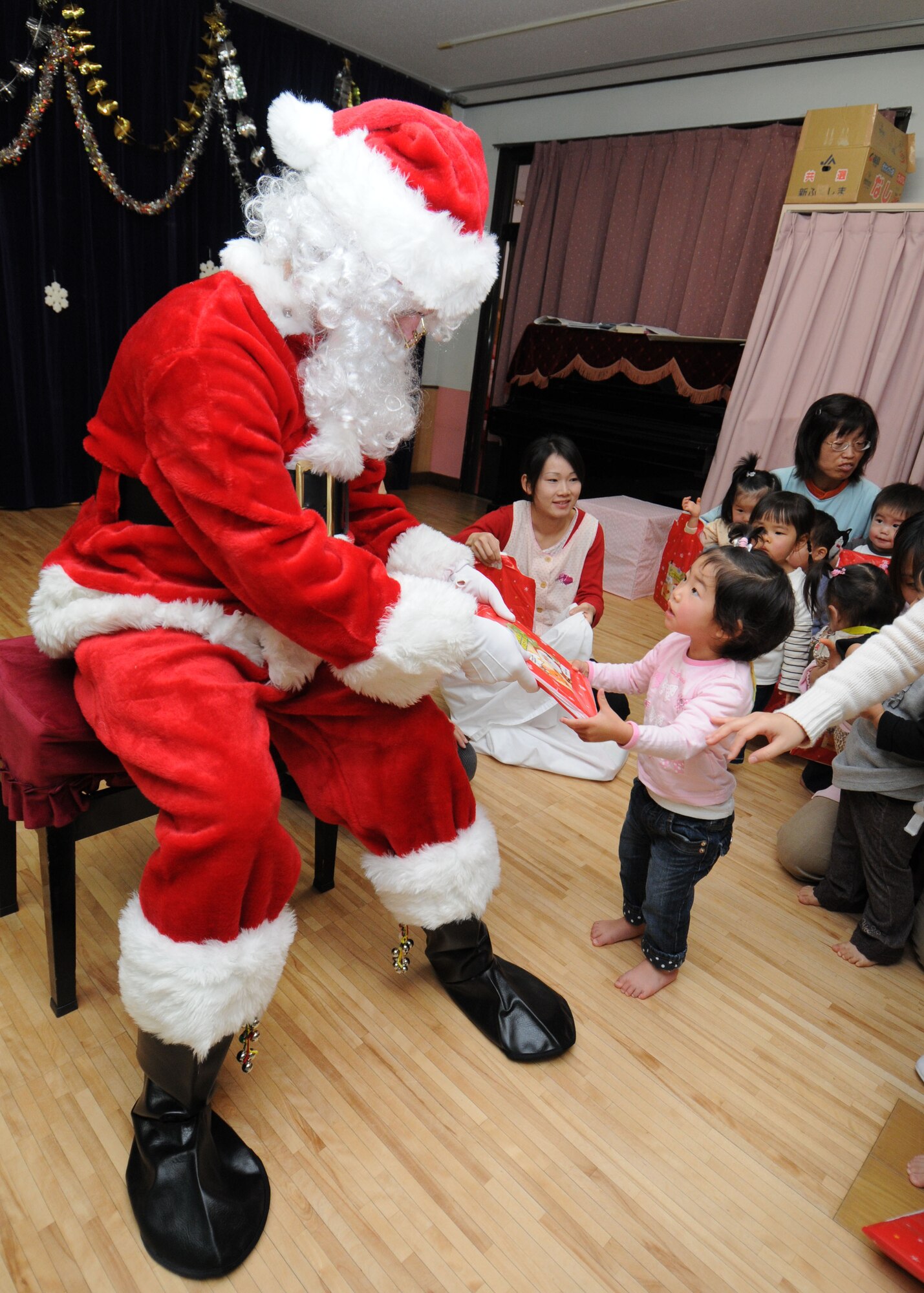 YOKOTA AIR BASE, Japan -- Airman Sean "Santa"  Martin from the 374th Airlift Wing Public Affairs office  visits children at the Kamigana elementary school, Ome City, Dec. 18. During his visit Santa handed out gifts and answered the childrens questions.
(U.S. Air Force photo by Senior Airman Veronica Pierce)