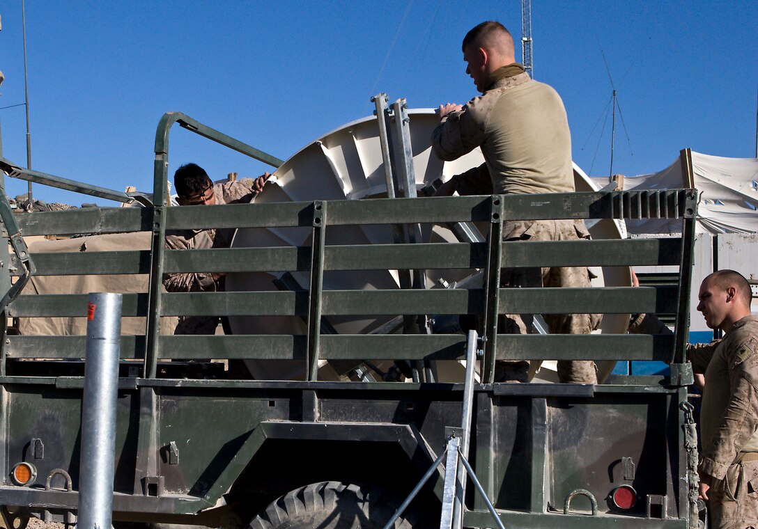 Marines from Company C, Task Force 1st Battalion, 3rd Marine Regiment, Regimental Combat Team 1, load equipment from Karmah Iraqi Police Station December 18. Marines departed KIPS throughout December as Iraqi police have progressed their operational capabilities and no longer need direct assistance from Coalition Forces. (U.S. Marine Corps Released)