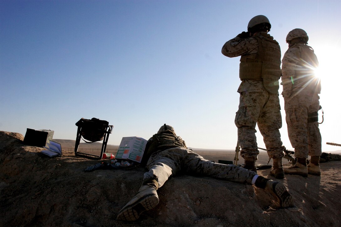 Snipers with Scout Sniper Platoon, Task Force 1st Battalion, 2nd Marine Regiment, Regimental Combat Team 5, fire on targets positioned on the hills surrounding Combat Outpost Rawah, Iraq, Dec. 18. The purpose of the training was to increase the proficiency levels of the snipers, while adapting both their weapons systems and themselves to the climate changes of a new area of operations.