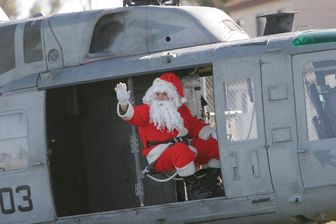 Santa Claus waves hello to the students of Stuart Mesa Elementary School, Marine Corps Base Camp Pendleton, Calif., Dec. 19. Santa was dropped off by Marines flying a UH-1N helicopter.