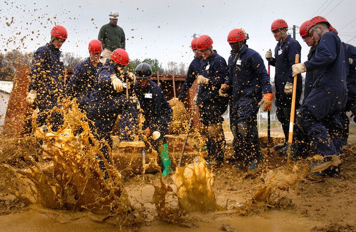 Students in the basic course at the Chemical, Biological Incident Response Force remove debris at the opening as they try to enter a simulated building collapse in search of survivors. More than 400 Marines, sailors and civilians are assigned to the specialized unit that trains around the United States to decontaminate and extract victims from a disaster site.