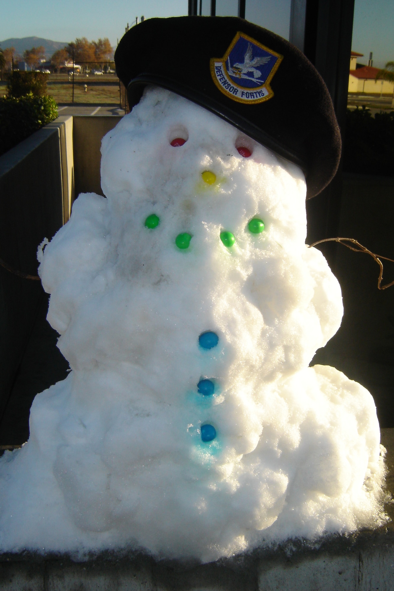 A Security Forces snowman, built by gate guards Dec. 19 out of snow from a passerby, greets Team March members as they enter the Main Gate.  Nearly every driver made a cheerful comment about the rare sight. (U.S. Air Force photo by Will Alexander)