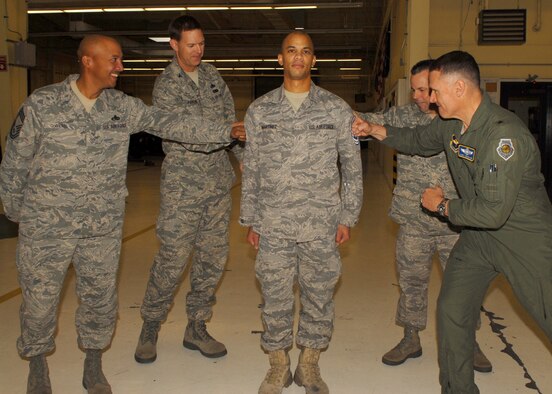 Chief Master Sgt. Timothy Owens, 56th Maintenance Group superintendent, Col. Geoffrey Parkhurst, 56th Maintenance Group Commander, Chief Master Sgt. Randall Raper, 56th Fighter Wing Command Chief, and Brig. Gen. Kurt Neubauer, 56th Fighter Wing Commander, tack on Master Sgt. status onto the former Tech. Sgt. Jerry Martinez Jr., 56th Component Maintenance Squadron, during a sneak STEP promotion Dec. 18.  The Stripes for Exceptional Performers program allows commanders the opportunity to promote deserving Airmen when they are not selected for promotion through the traditional Weighted Airmen Promotion System. (U.S. Air Force photo by Airman 1st Class Ronifel Yasay) 