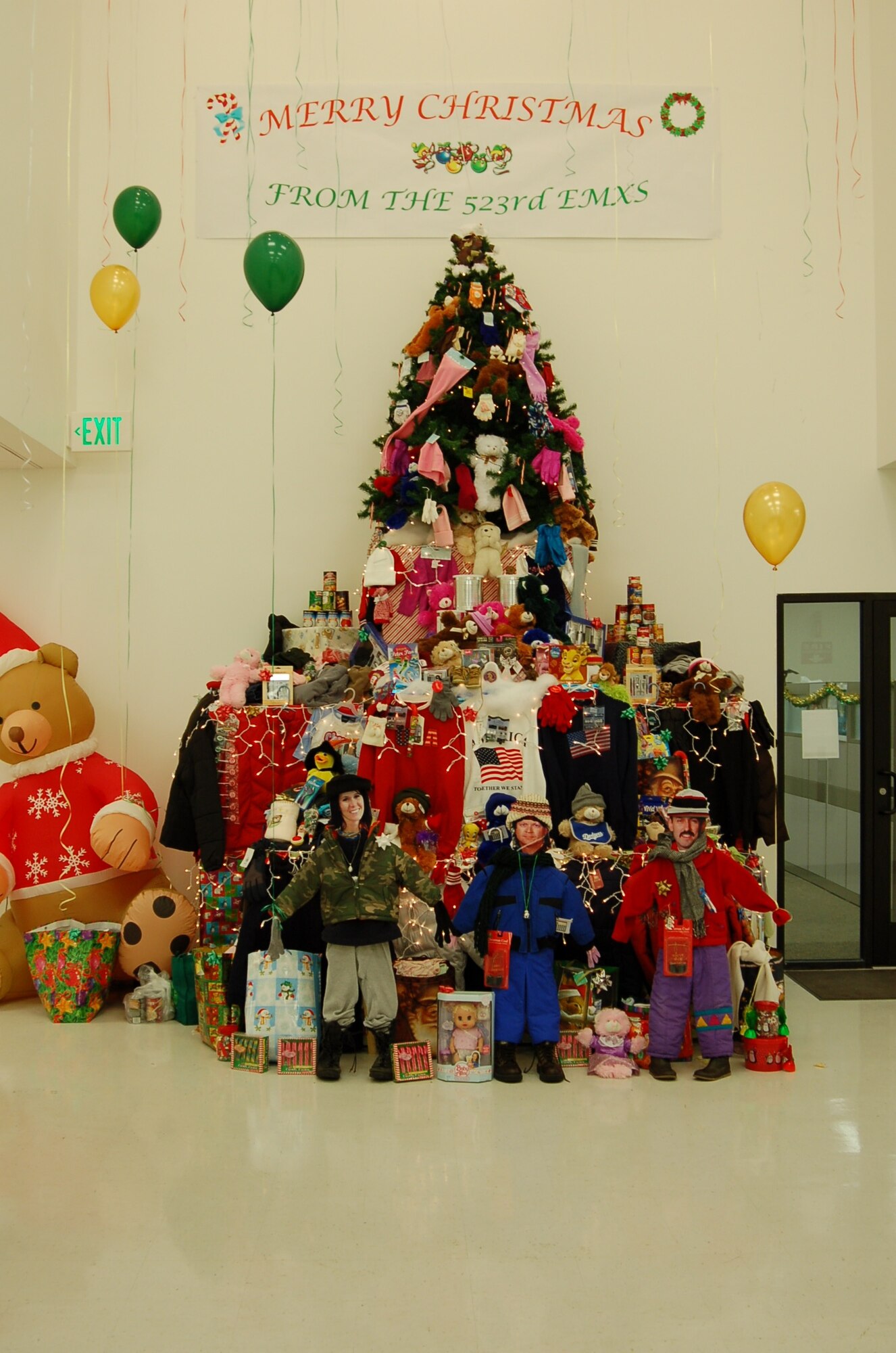A nearly 14-foot “can tree” decorated by the 523rd Electronics Maintenance Group, towers nearly 14 feet in Bldg. 5, decorated with sweaters, coats, scarves, sweatshirts, shoes, toys and food items. The five 309 EMXG squadrons held a competition to collect food items and display them in a Christmas setting, and the 523rd entry was selected as “most creative.”  The more than 2,200 food items, clothing and toys collected will be taken to local charities.