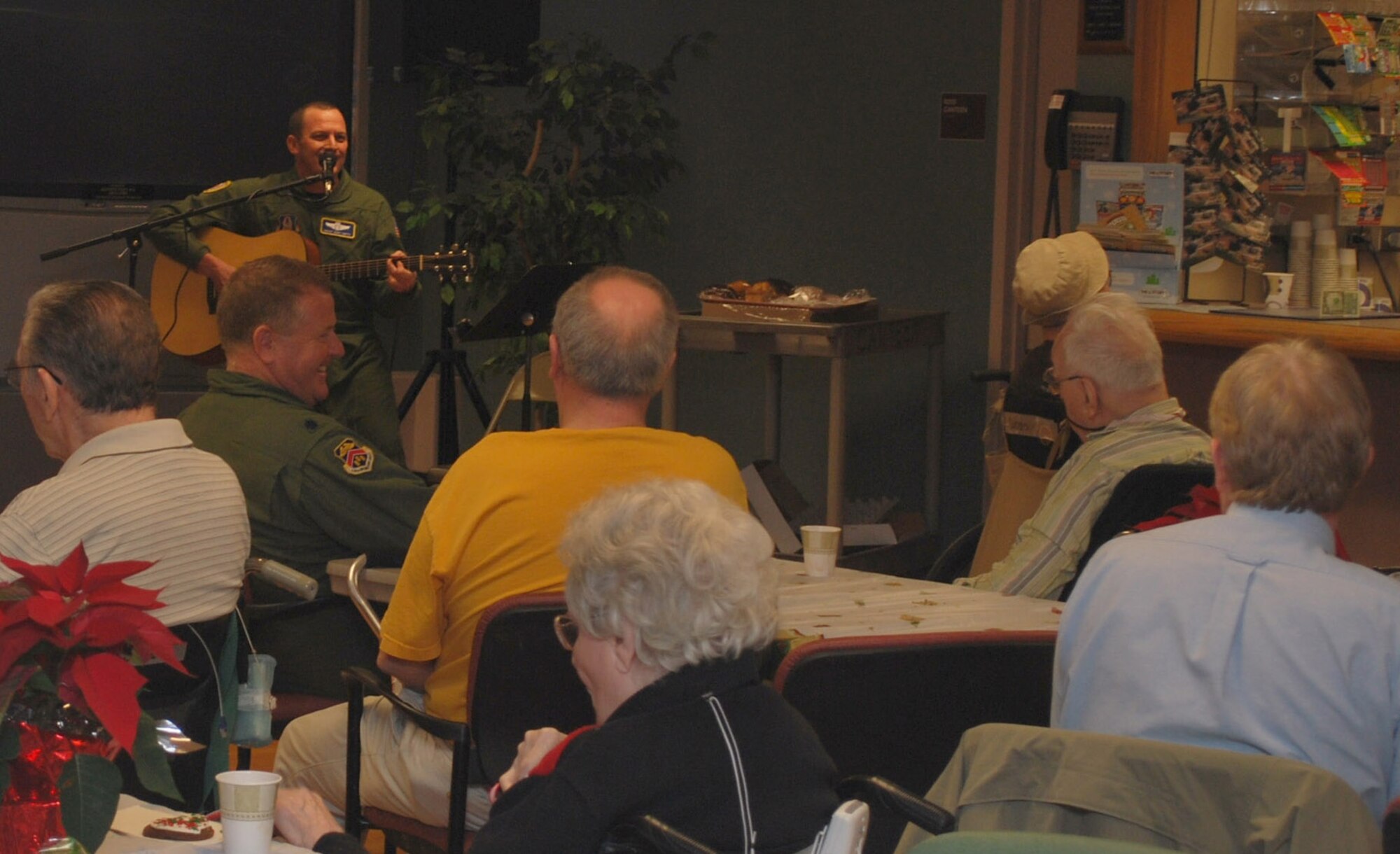 Senior Master Sgt, Gary Smith plays guitar and sings Christmas carols for the veterans at the Soldiers' Home in Holyoke, Mass., Dec. 18. Sergeant Smith and more than 30 other reservists from the 439th Airlift Wing at Westover paid a holiday visit to the veterans. (US Air Force photo/Tech. Sgt. Andrew Biscoe)