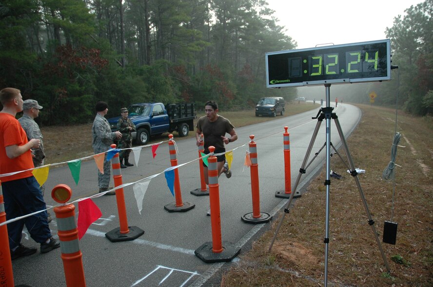 Juan Moran, Air Force Special Operations Command Special Tactics Training Squadron, crosses the finish line in the First annual Eglin/Hurlburt Cross Country Challeng, leadind the Hurlburt Team to victory.STTS took home the first place trophy, with second and third place going to the 6th Special Operations Squadron and the AFSOC headquarters team, respectively. (U.S. Air Force photo /2nd Lt. Mark Lazane)