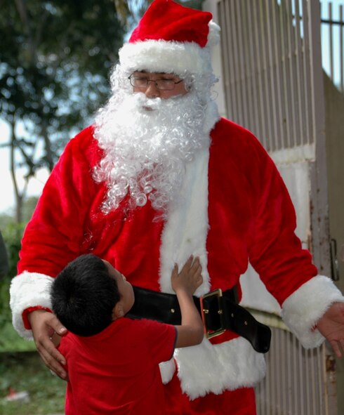 Santa Claus, played by Staff Sgt. Daniel Rosas, 6th Special Operations Squadron, greets a young Honduran boy recently after arriving at his orphanage as part of the 1st Special Operations Wing's annual OPERATION CHRISTMAS WISH. This year marked the 16th iteration of the event, in which Airmen delivered supplies to multiple Honduran orphanages and conducted joint military training with U.S. forces abroad. (U.S. Air Force Photo/2nd Lt. Mark Lazane)