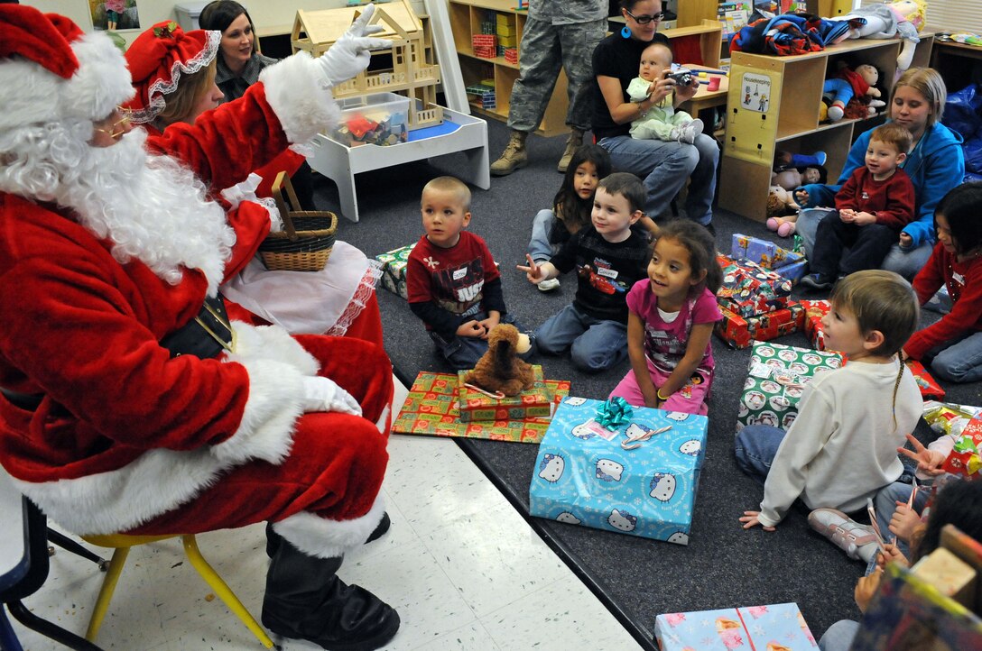 Santa gives a countdown of three to children to open presents at the Youth and Family Services Child Care Center in Rapid City, S.D., Dec. 18, 2008. YFS staff provided the names and ages of infants, toddlers and preschool-aged children in their program to 28th Operations Group members, who then purchased and wrapped gifts for every child. (US Air Force photo/Airman 1st Class Corey Hook)