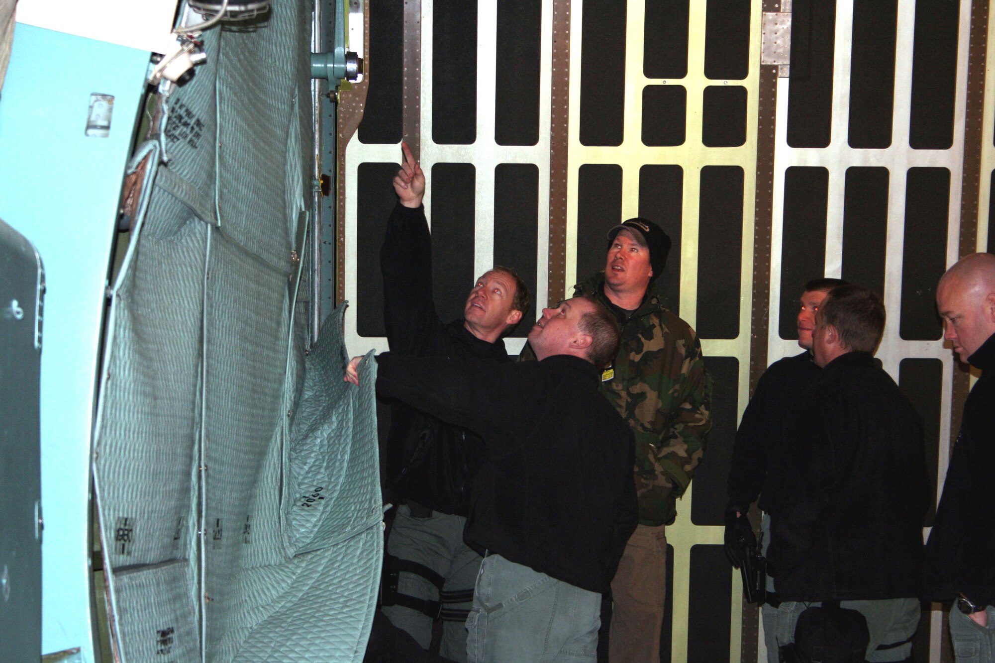 WRIGHT-PATTERSON AFB, Ohio - Tech. Sgt. John Stevens, 445th Aircraft Maintenance Squadron, familiarizes members of the Dayton SWAT team with the C-5 during training for emergency support teams. The Dayton SWAT team would respond with 88th Air Base Wing Security Forces during an Air Piracy/Hijacking situation. (Air Force photo/Laura Darden)