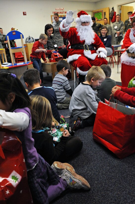 Children open presents at the Youth and Family Services Child Care Center in Rapid City, S.D., Dec. 18, 2008. YFS staff provided the names and ages of infants, toddlers and preschool-aged children in their program to 28th Operations Group members, who then purchased and wrapped gifts for every child. (US Air Force photo/Airman 1st Class Corey Hook)